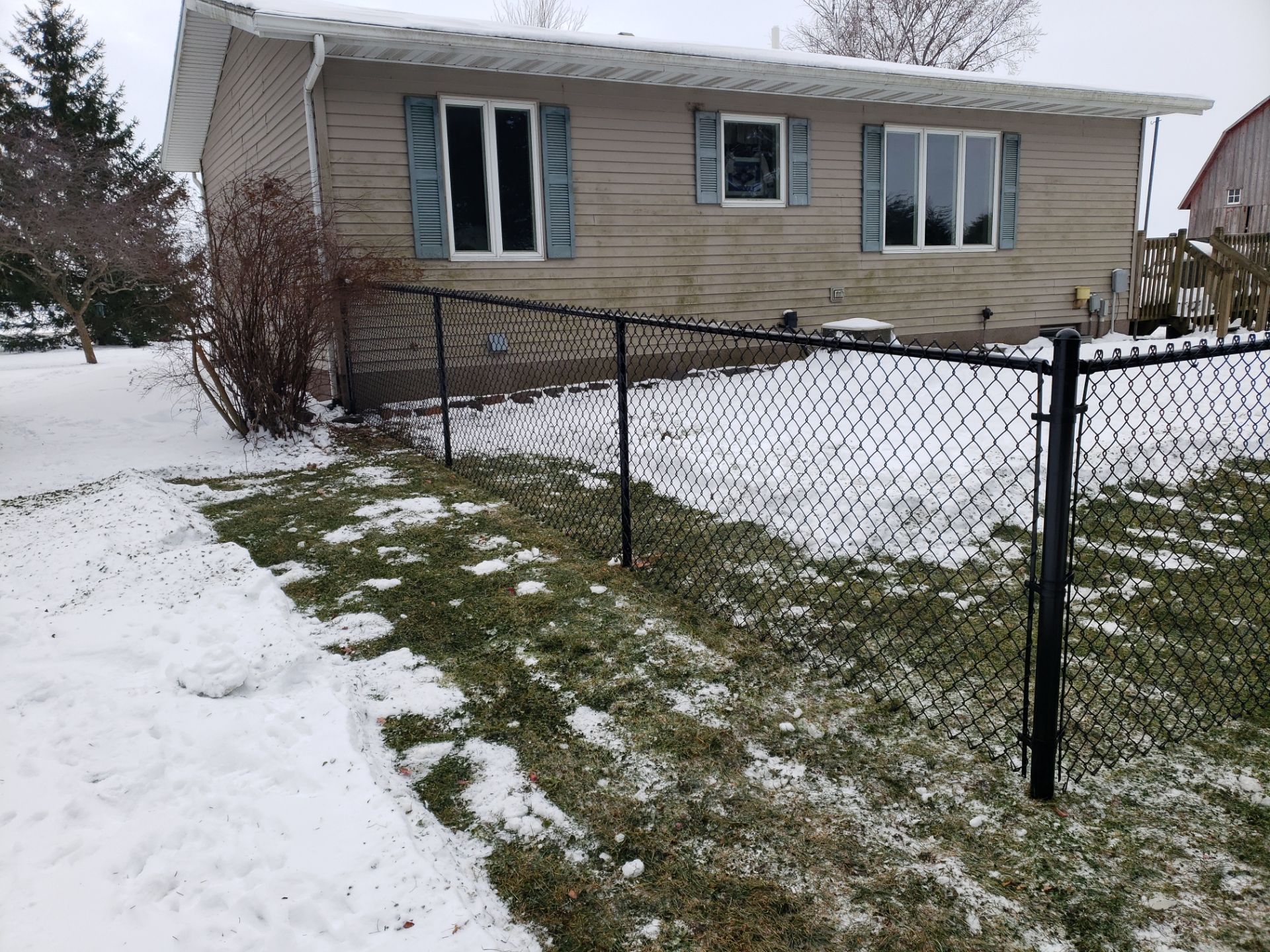 Black Vinyl-Coated Chain Link Fence Installation in Oelwein by Perfect Picket Fence and Stain