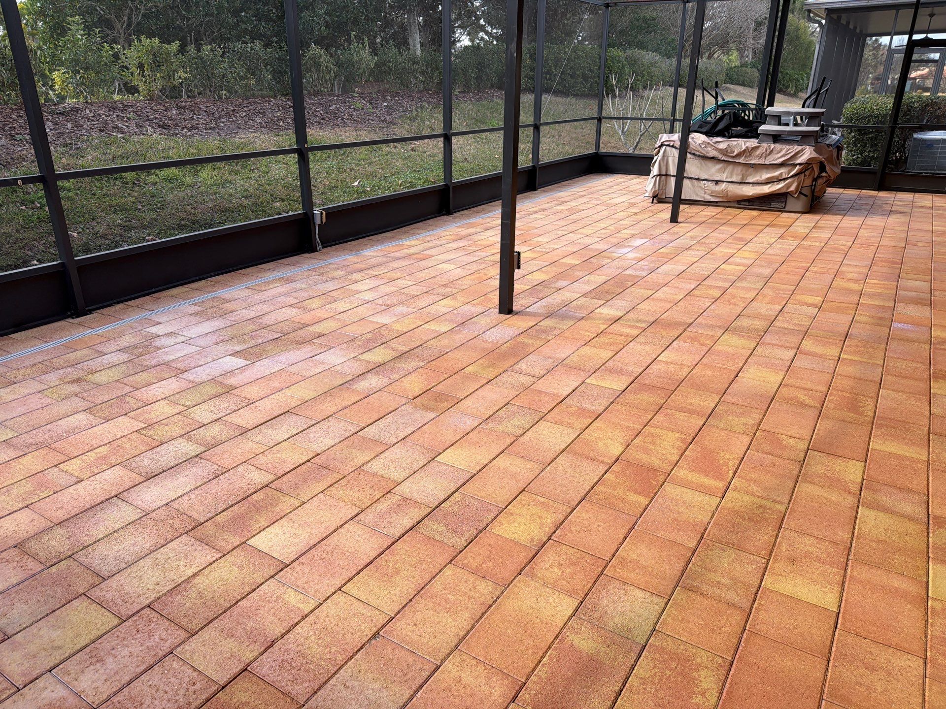 Paver Sealing for Herringbone Driveway and Screened Lanai in Valencia Lakes by Supreme Paver Experts
