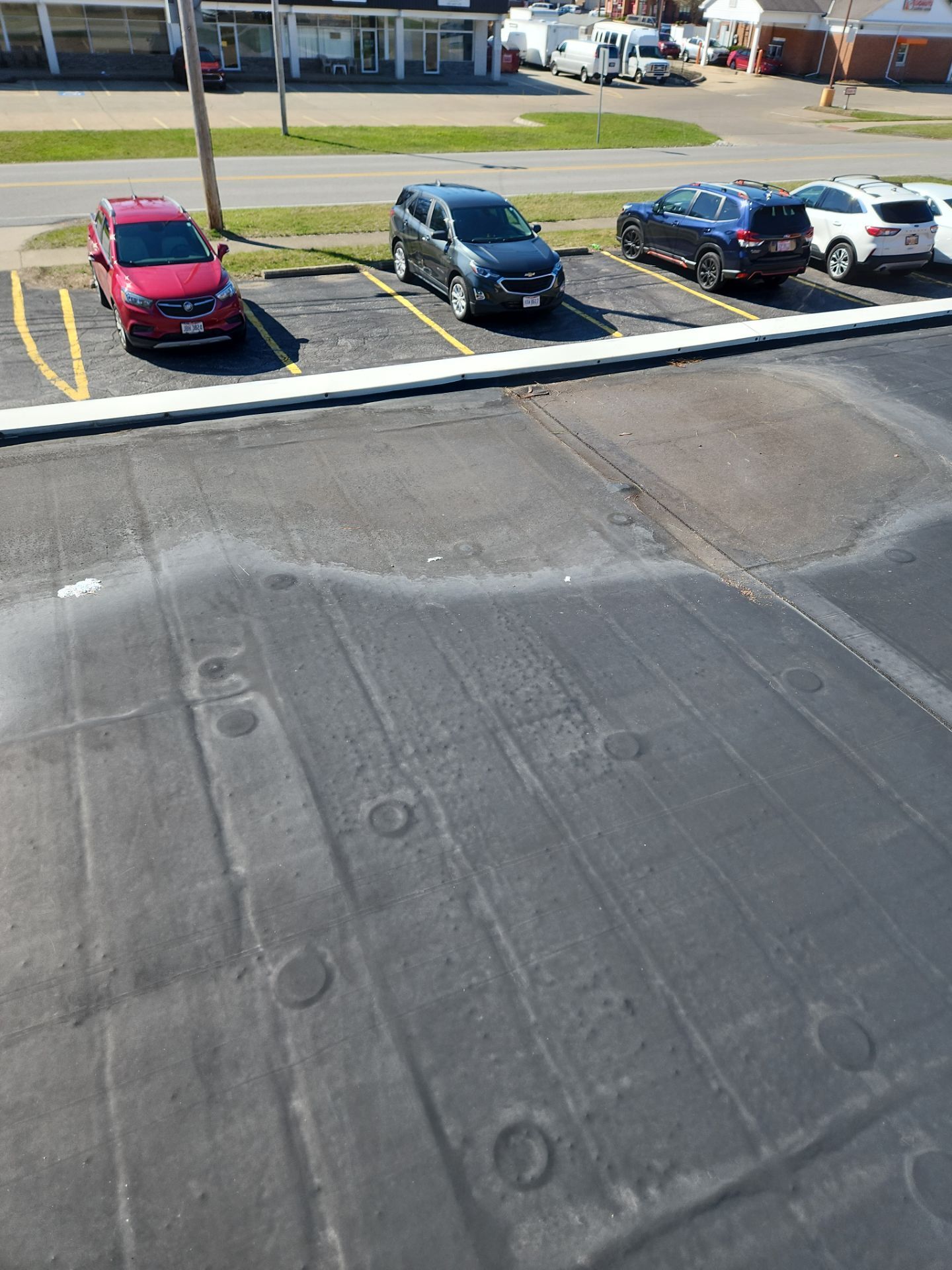 Commercial Roofing Repair using UniFlex Silicone Roof Coating on KinderCare Learning Center by 3 Daughters Construction 