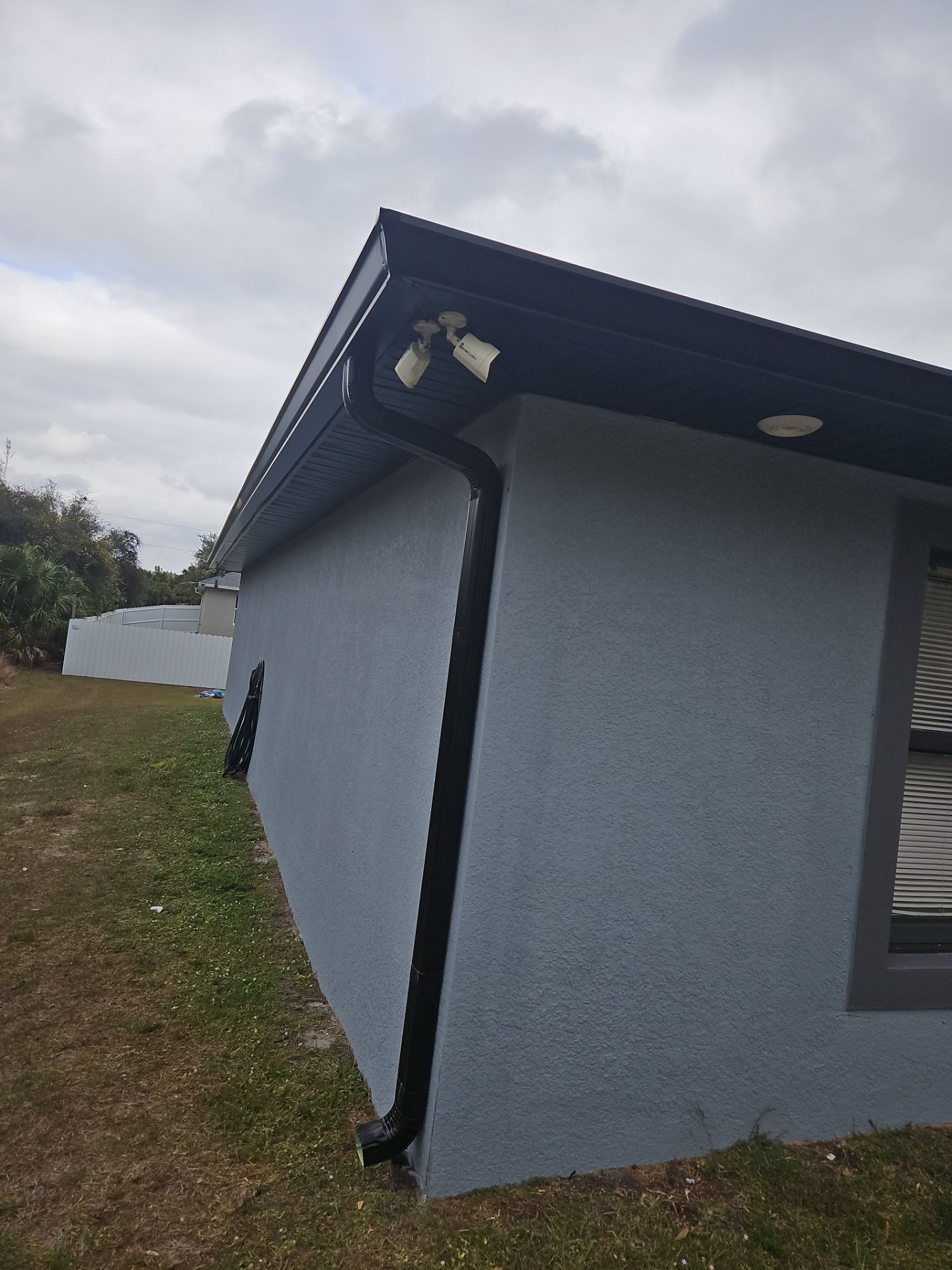 Black Seamless Gutters & Soffit/Fascia in Lehigh Acres FL by Gutter Professors