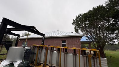 Equipment and standing seam metal roof on home.