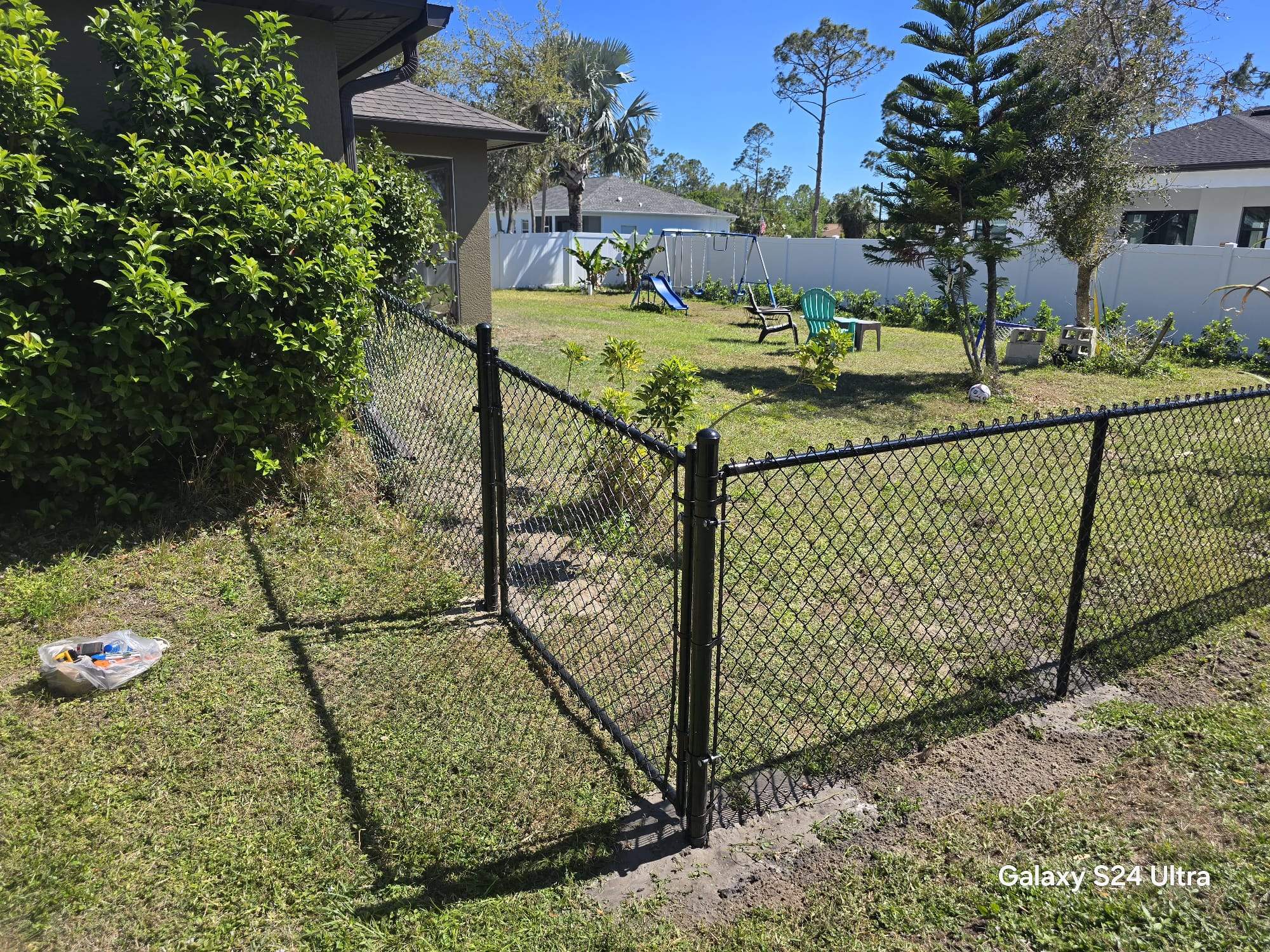 Residential Black Vinyl-Coated Chain Link Fence Installation in North Port by True Fence LLC