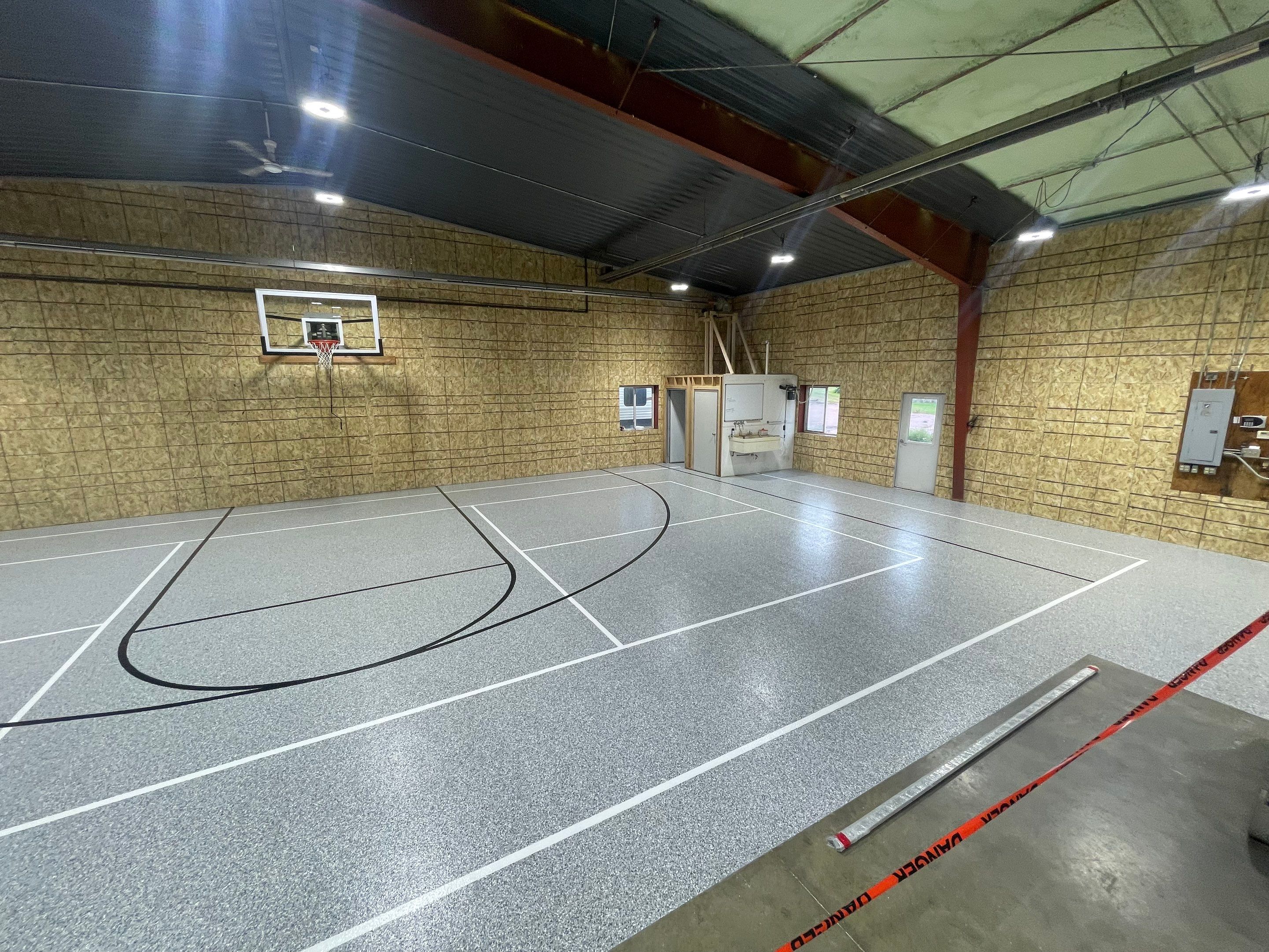Custom Polyurea Shop Floor with Basketball Court Lines in Rock Valley by Select Painting, Coatings & Garage Cabinets