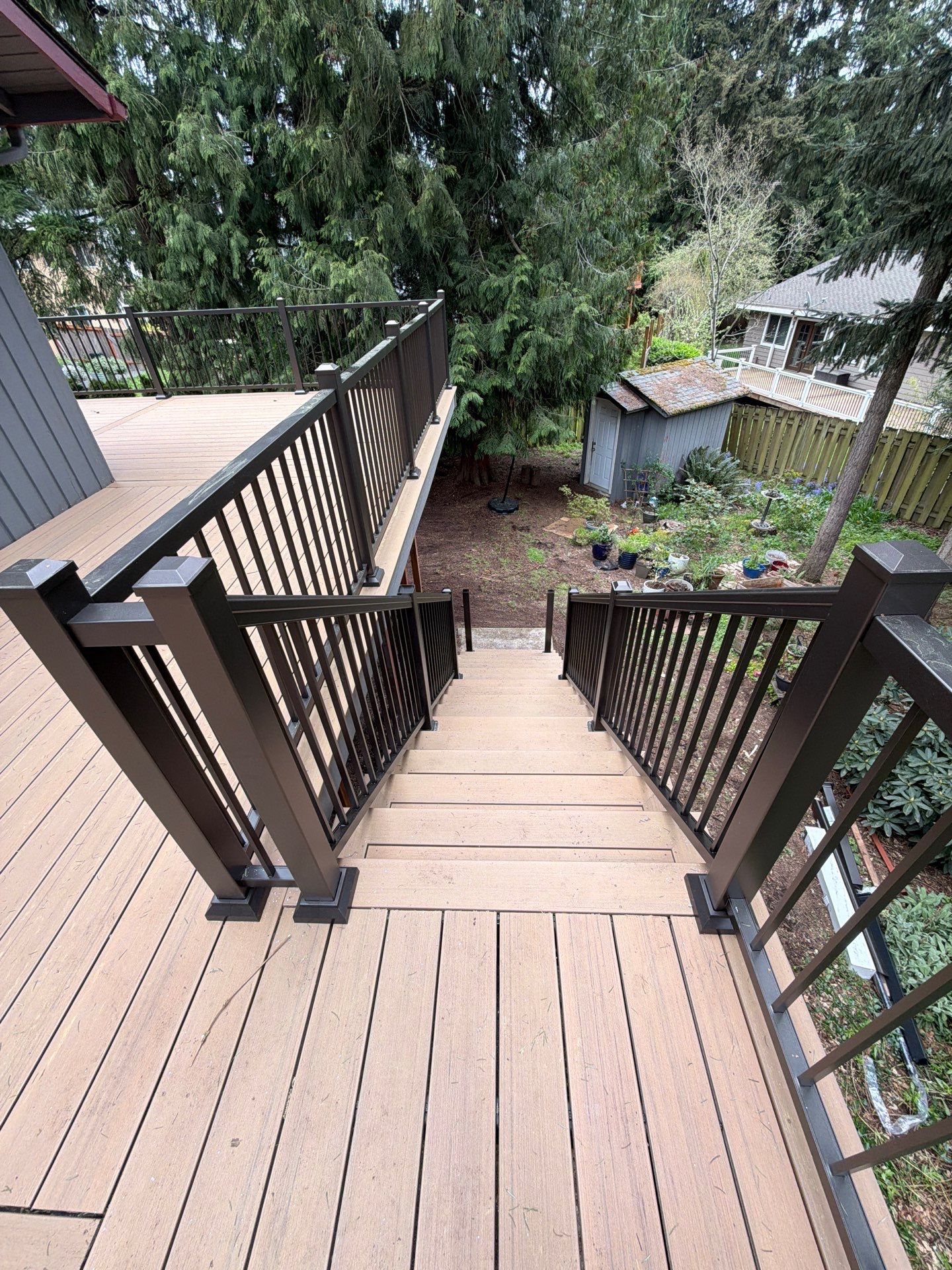 Elevated TimberTech Composite Deck Replacement With Black Metal Railings by Emerald City Energy