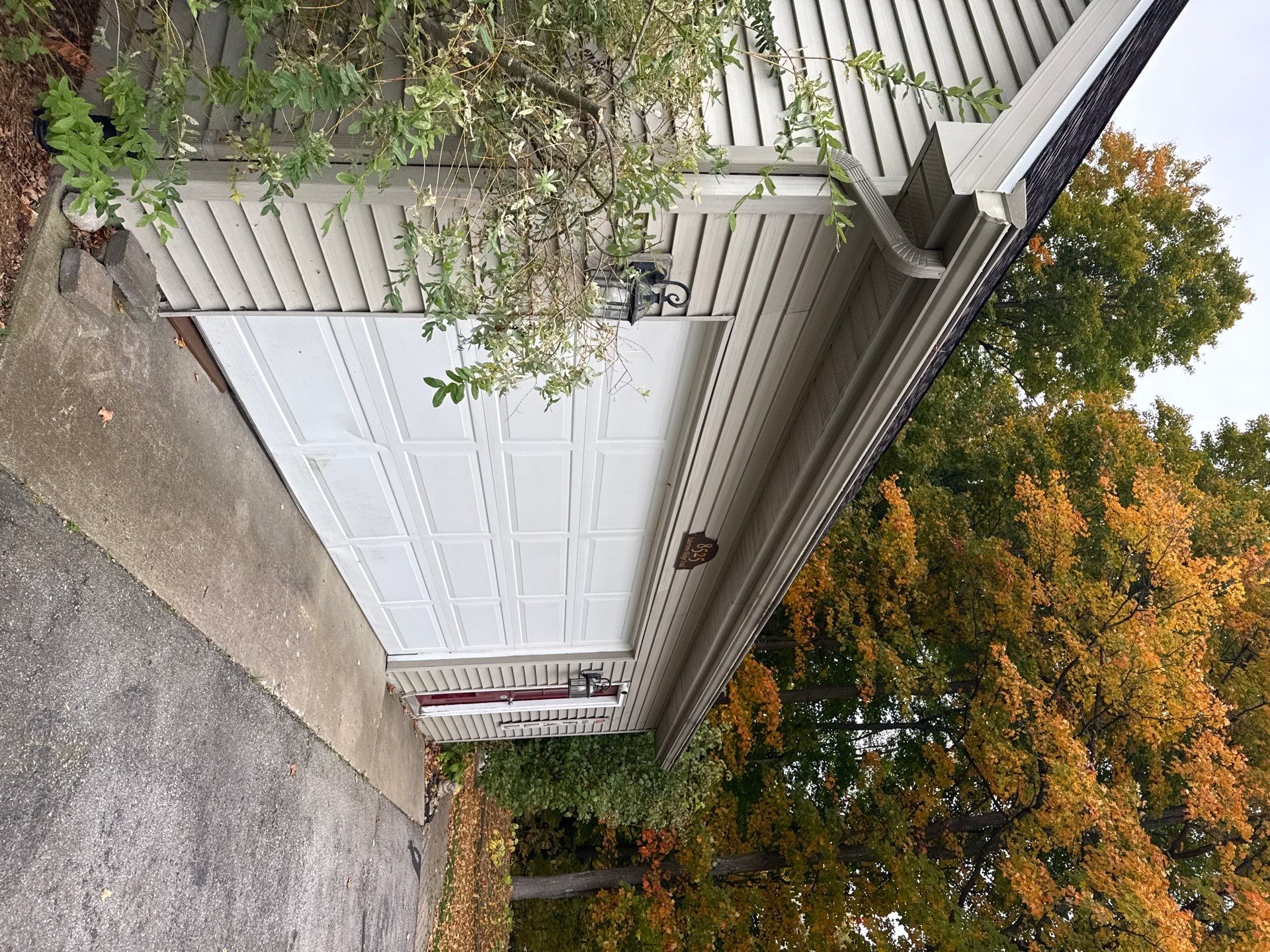 Traverse City Gutter Helmet Installation on a Shingled Roof Home by Rainbow Seamless Systems