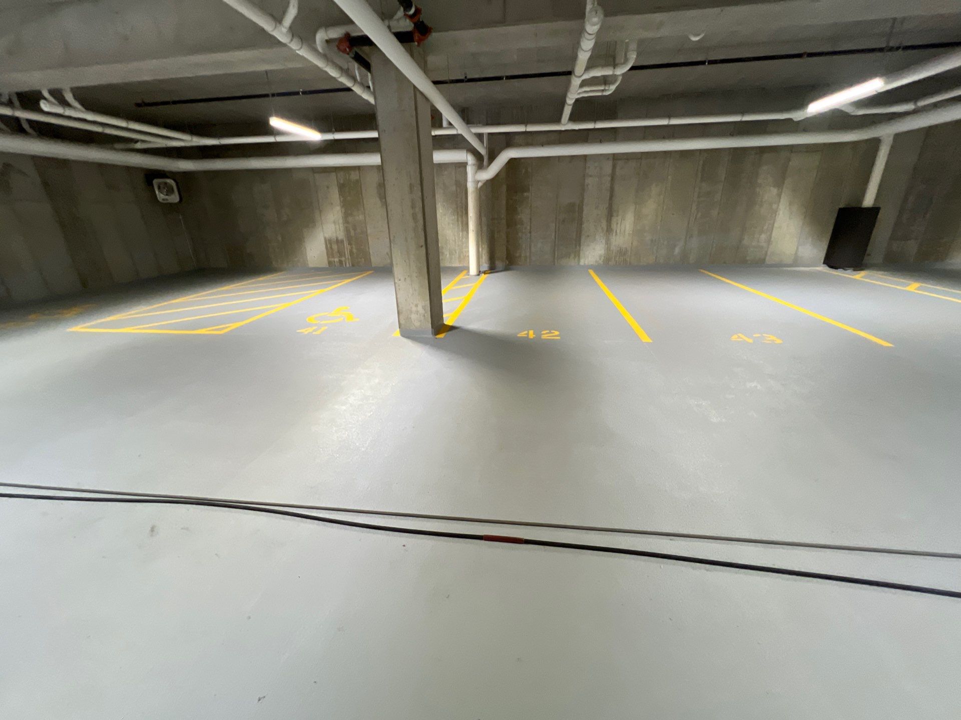 Parking garage using Hot water by Northern Power Washing LLC.