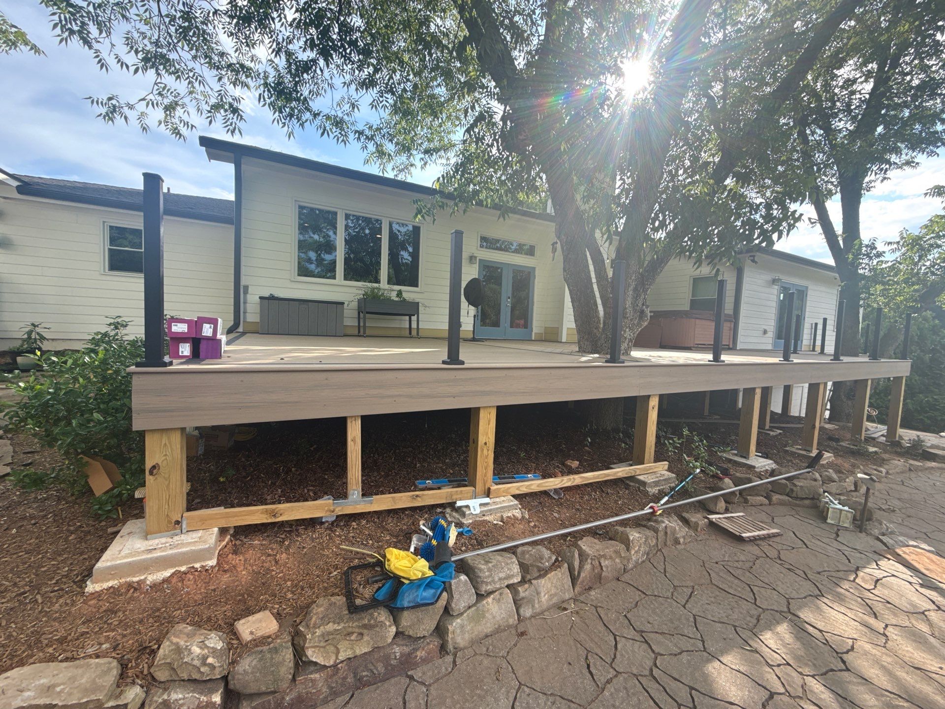 Deck Resurface with Glass Paneling and Deckorators Voyage Series Products by Nelson Exteriors 