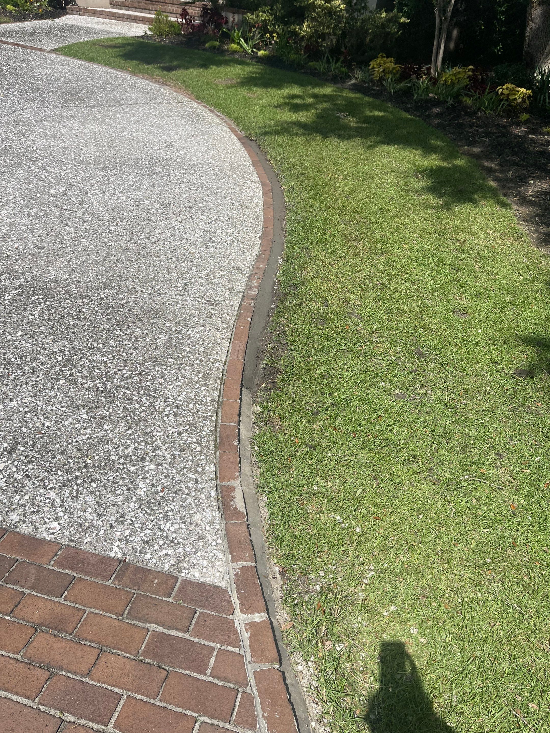 Custom Exposed Aggregate Driveway with Red Brick Borders in Hilton Head Island by Lowcountry Scapes, LLC