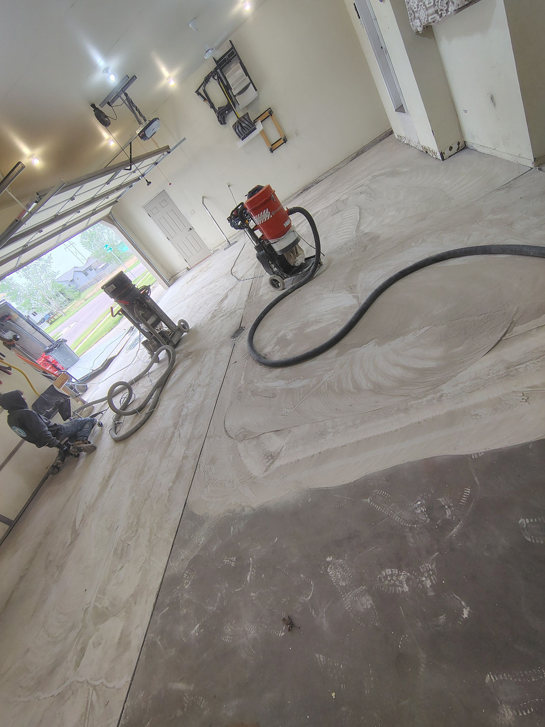 Sioux Falls Garage Floor Repair and Speckled Epoxy Coating Installation by Select Painting, Coatings & Garage Cabinets