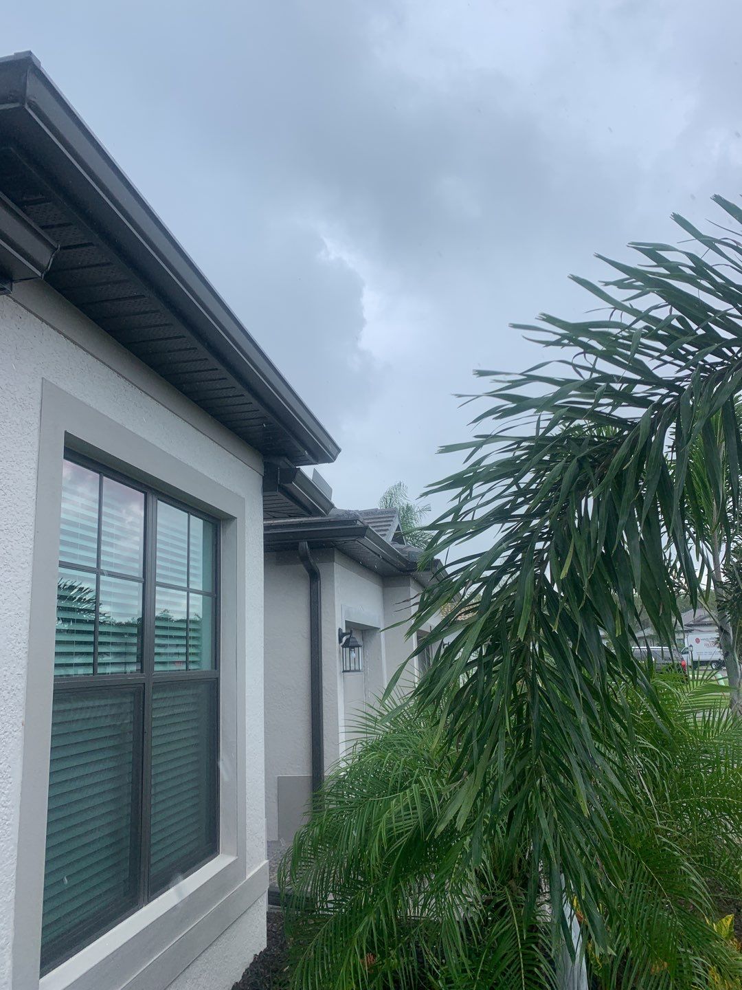 Seamless brown gutter and downspouts installation in Estero, FL  by Gutter Professors