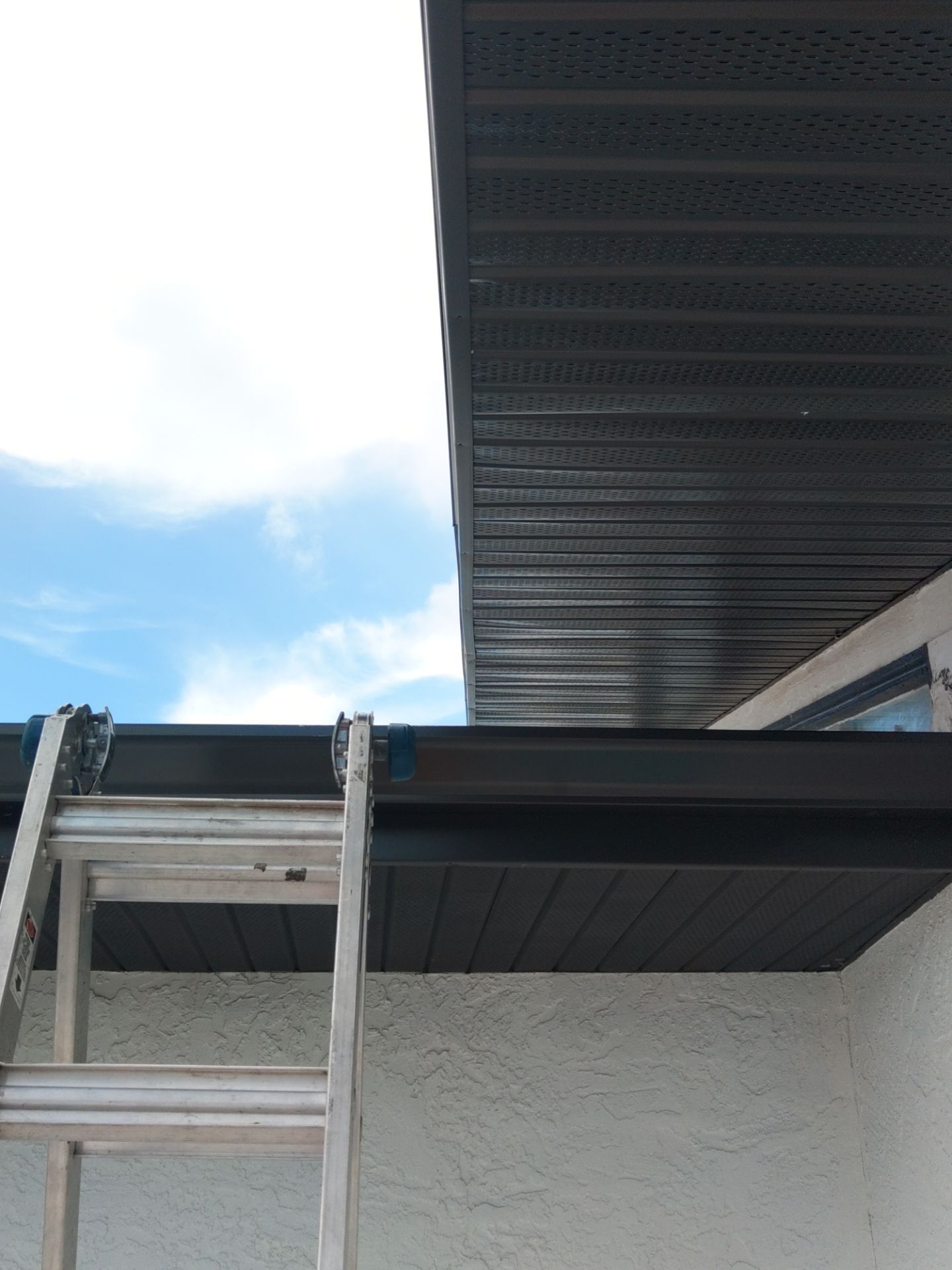 Black Seamless Gutters and Downspouts in Siesta Key FL by Gutter Professors