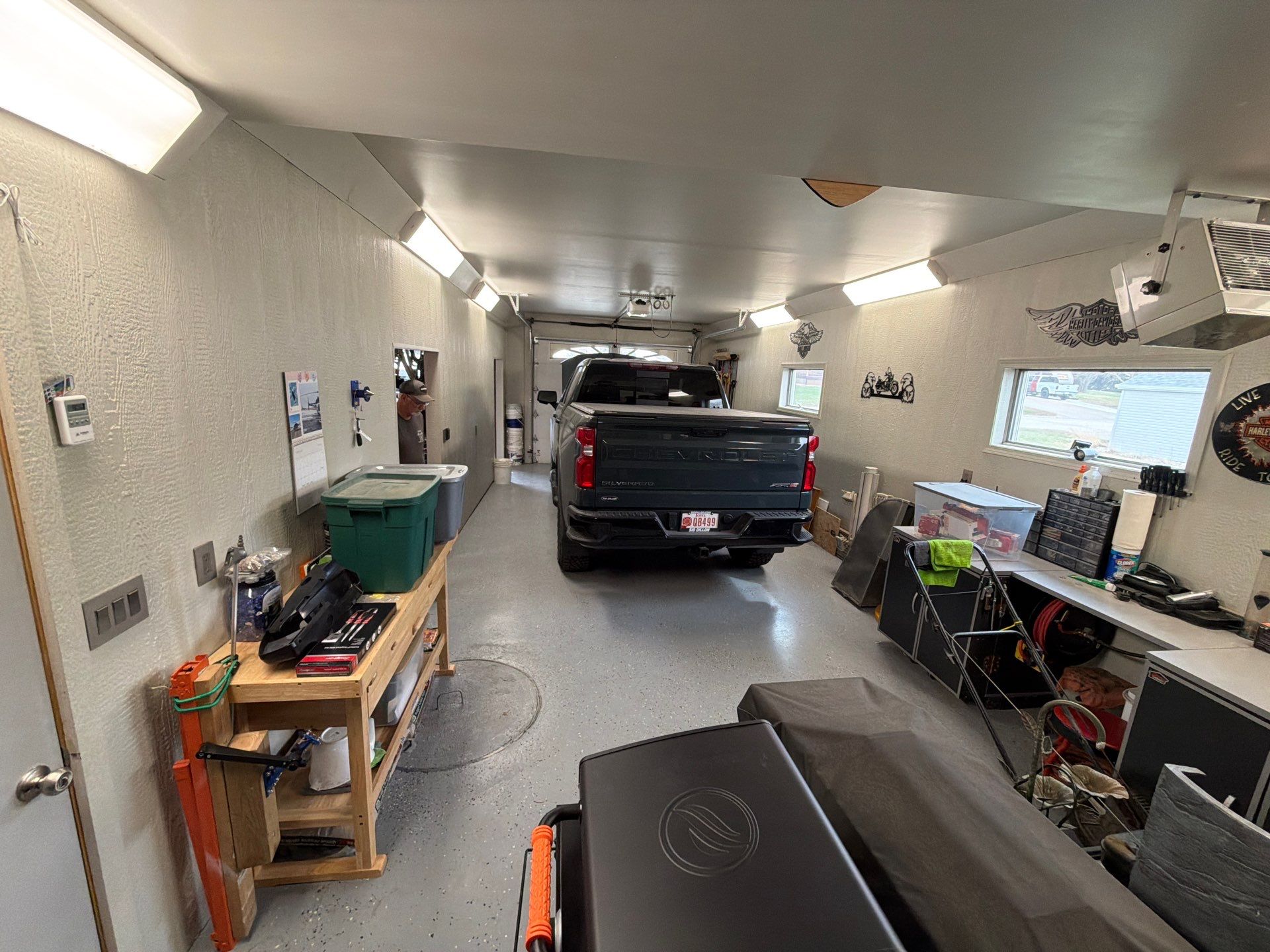 Custom Grey Flake Epoxy Garage Floor Installation in Remsen by Select Painting, Coatings & Garage Cabinets