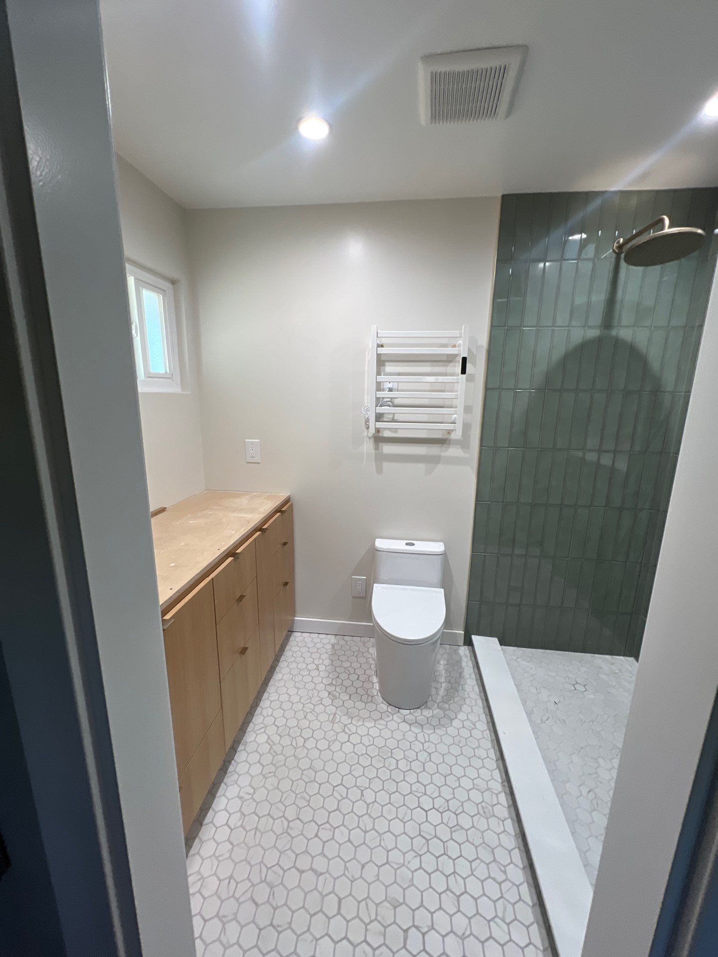 Custom Bathroom Remodel with Heated Floors and Vertical Sage Tile by  H4H Remodeling and Repairs Inc.