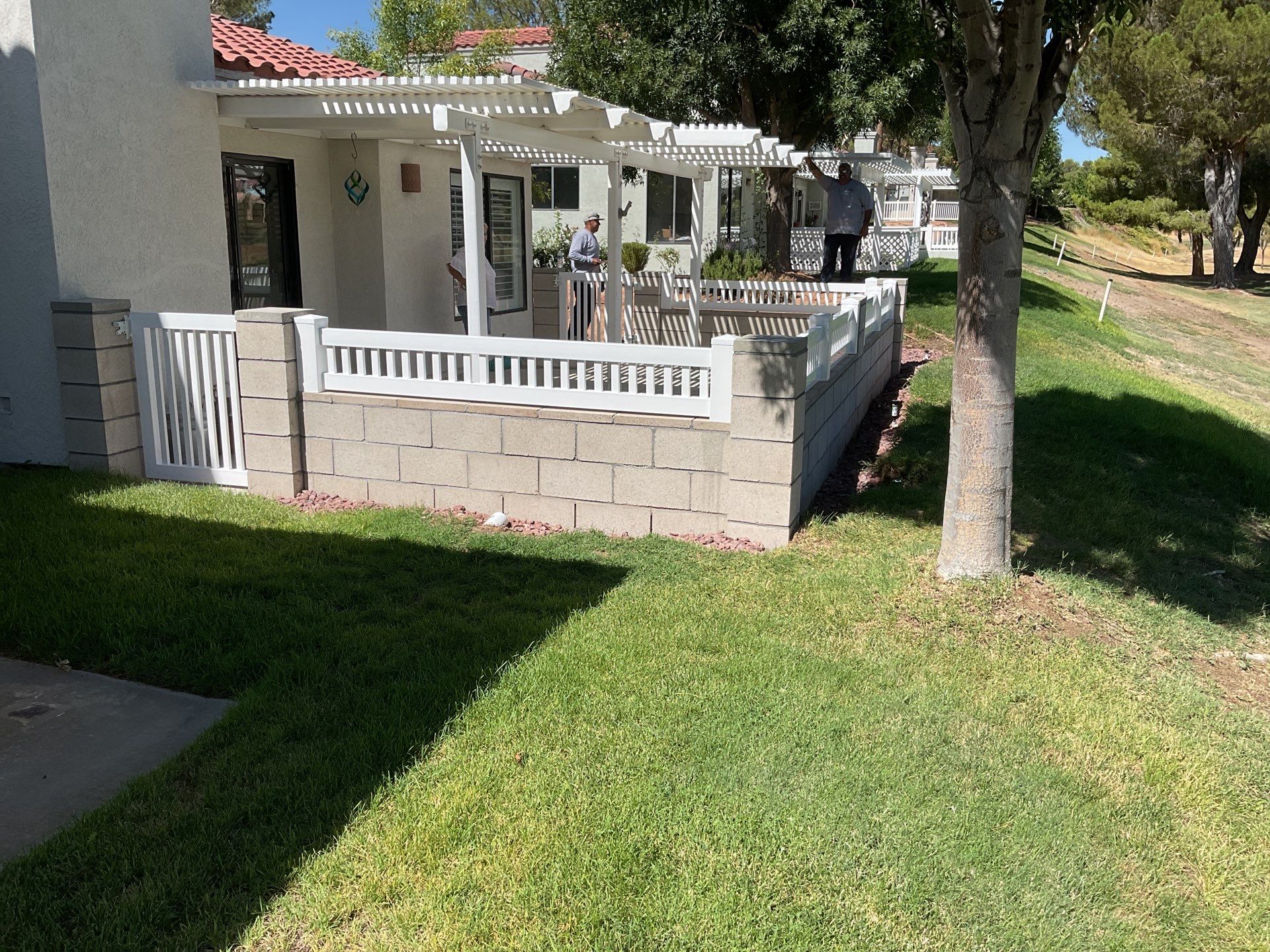White Box Picket Fence on top of block wall  by Fence Guys Inc. 