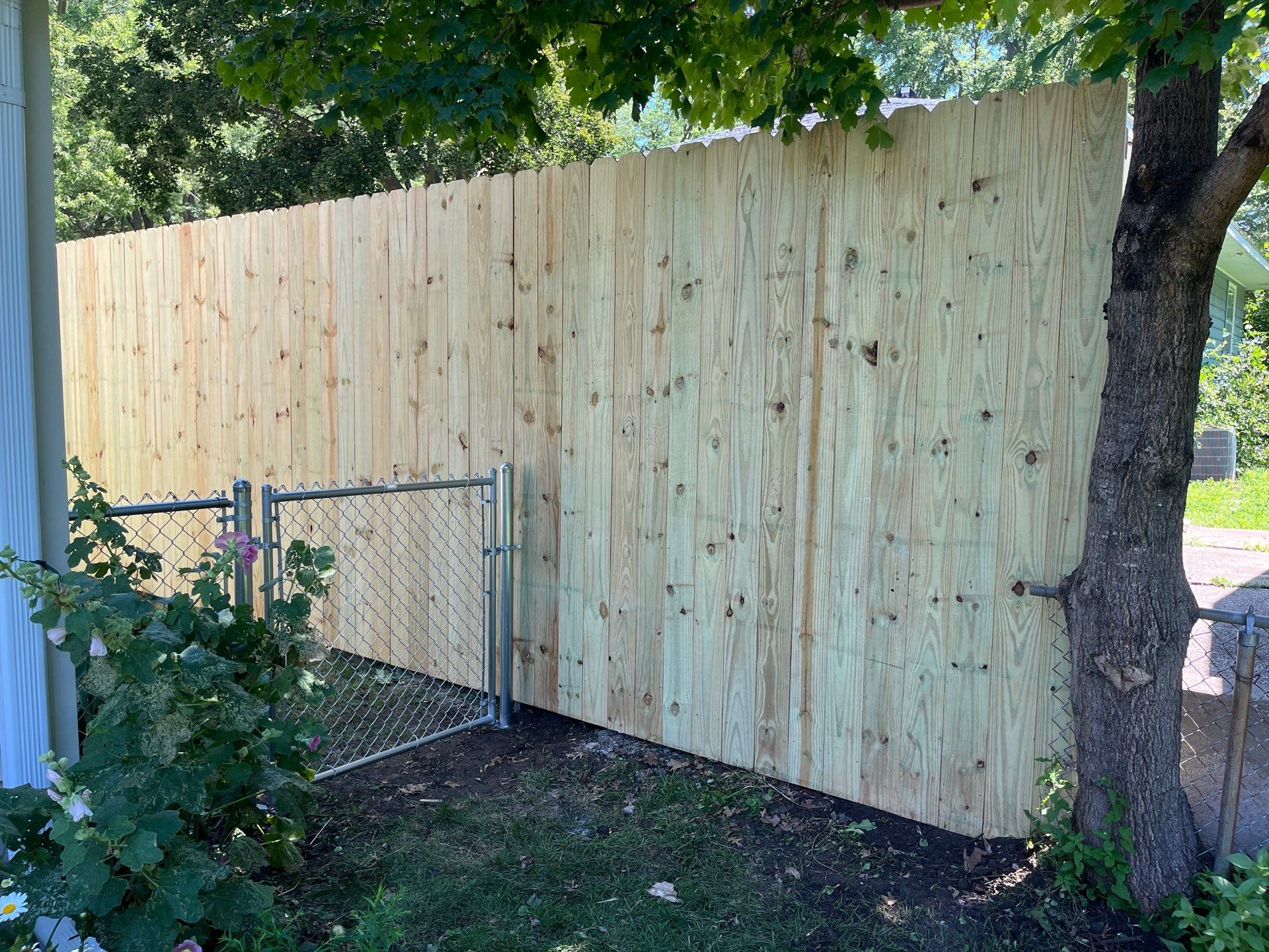 Pressure-Treated Wood Privacy Fence Installation in Cedar Falls by Perfect Picket Fence and Stain