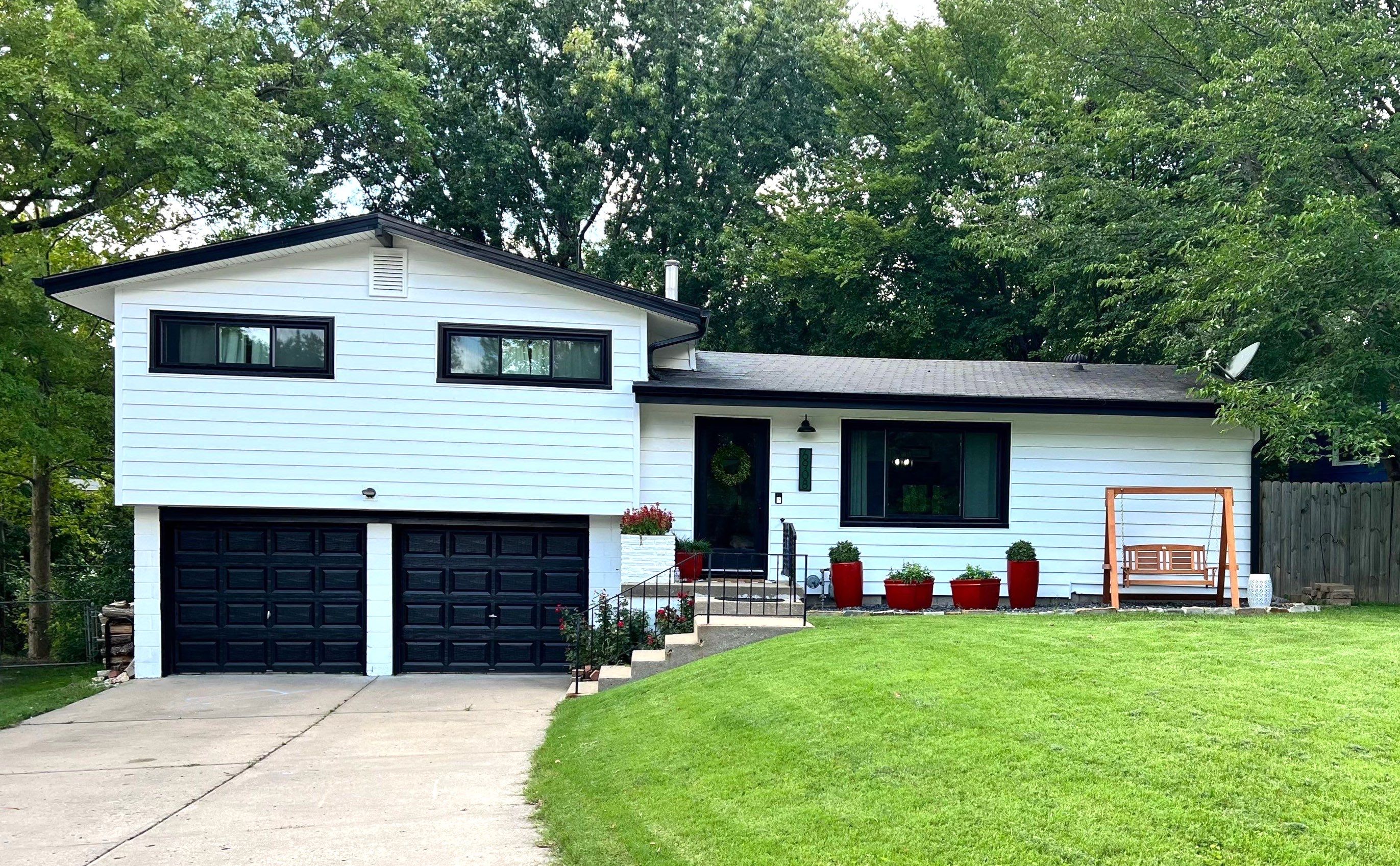 White Craneboard Siding and Heartland Window Installation in Parkville by EEC Windows, Siding & Roofing