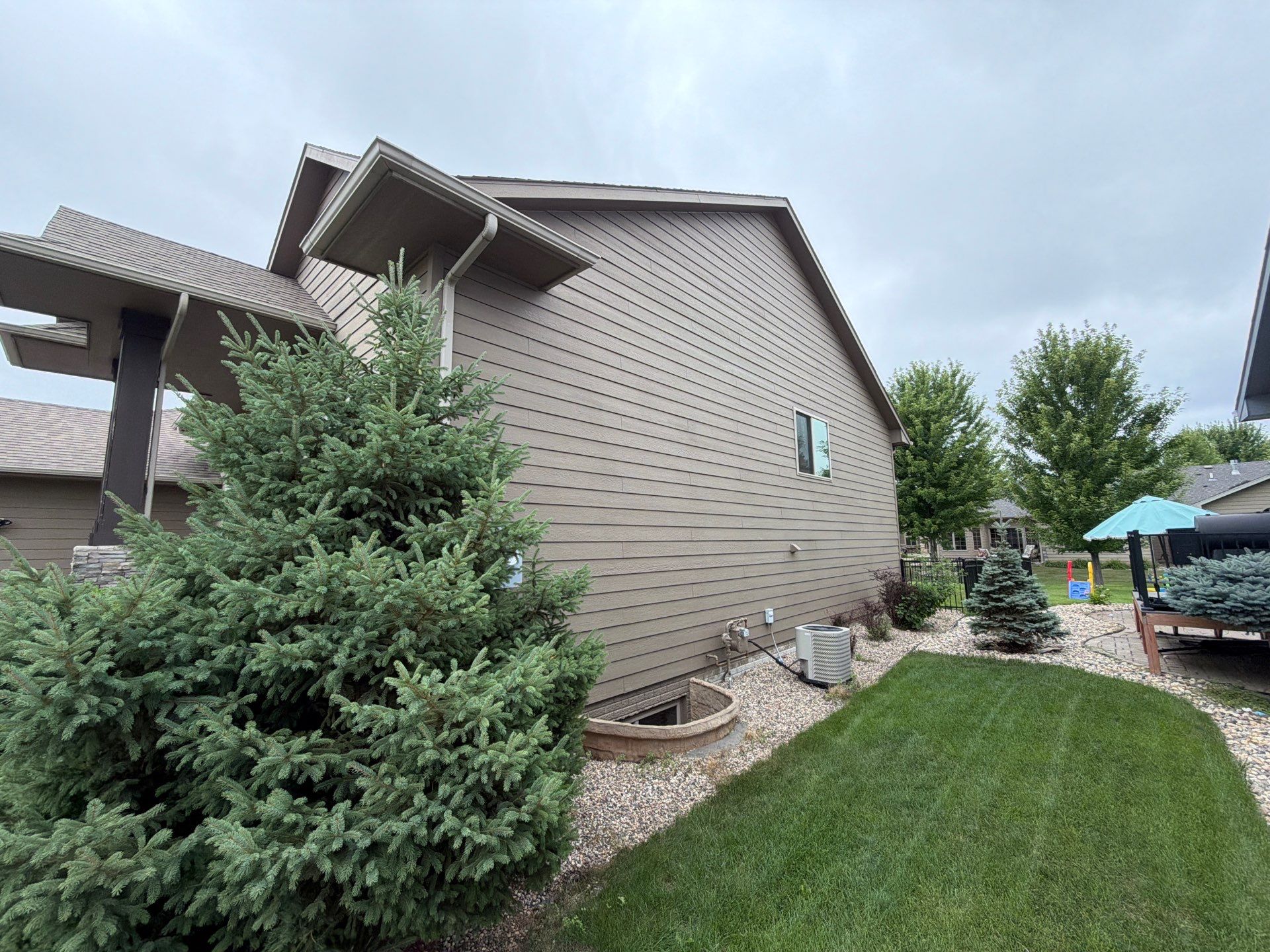 Full Exterior Siding Repaint for Sioux Falls Home and Garage by Select Painting, Coatings & Garage Cabinets