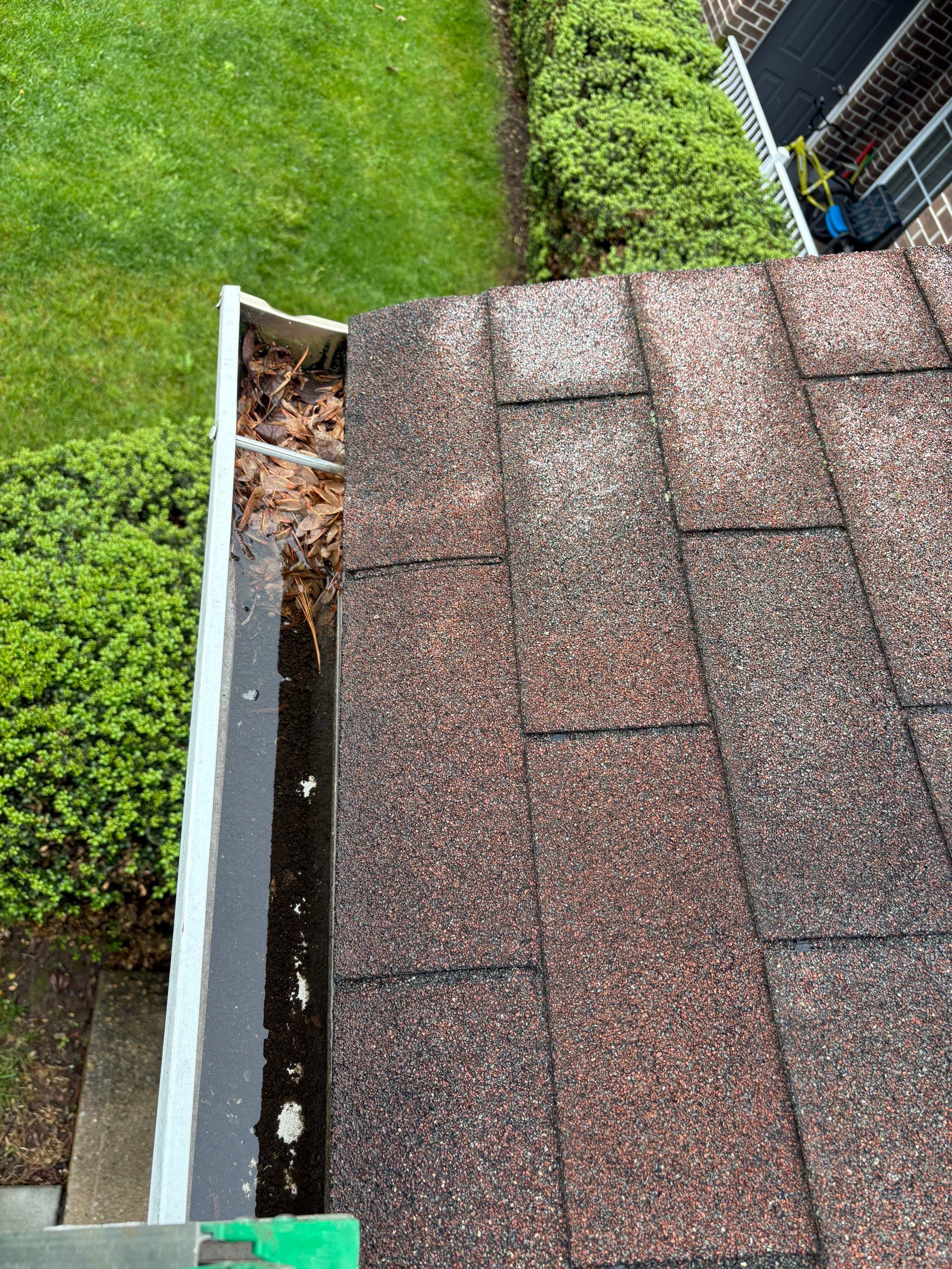 Commercial gutter cleaning Edison & New Brunswick before photo with filled gutters