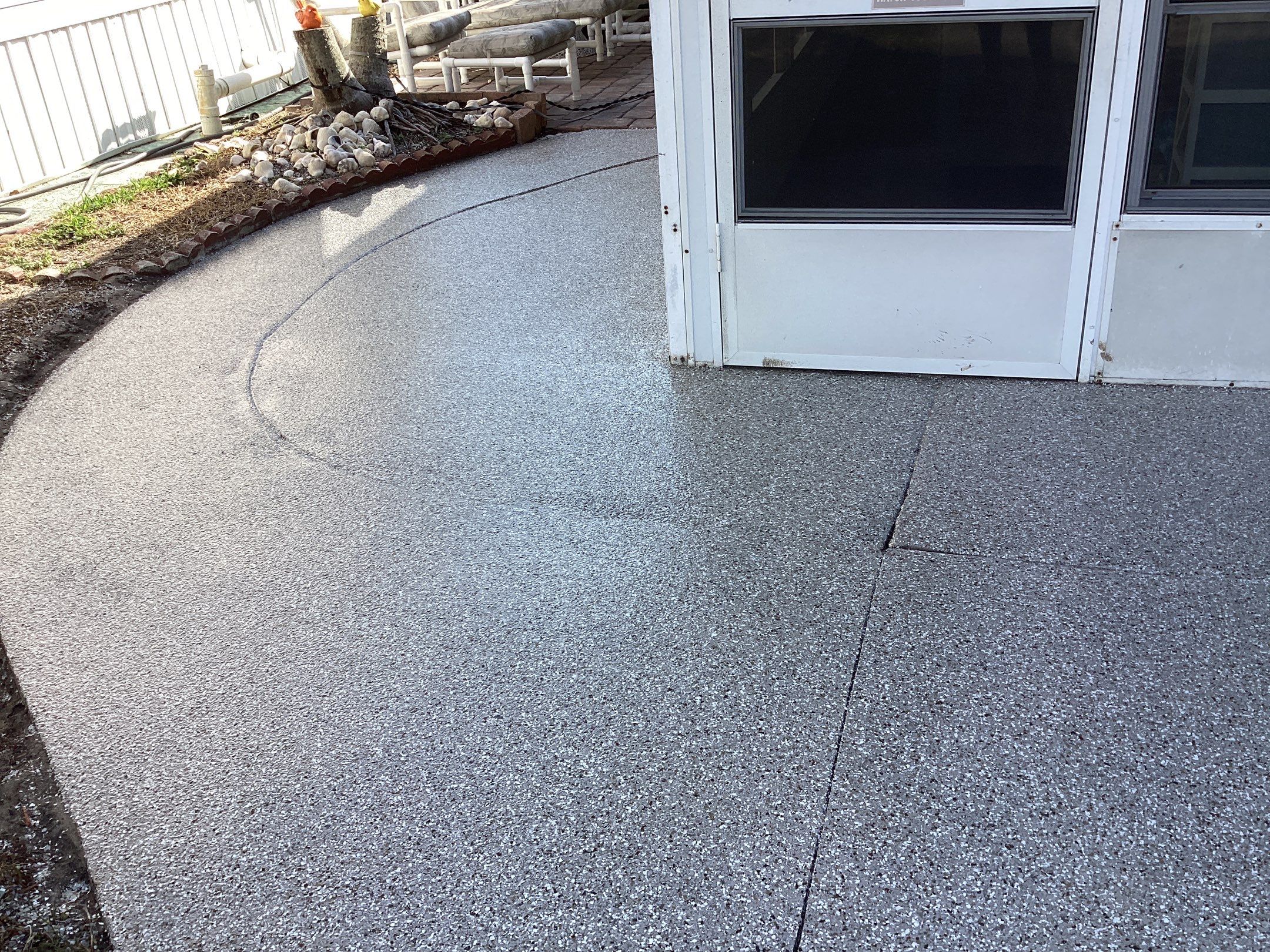 Driveway using Pebble Beach by Amvet concrete coatings llc