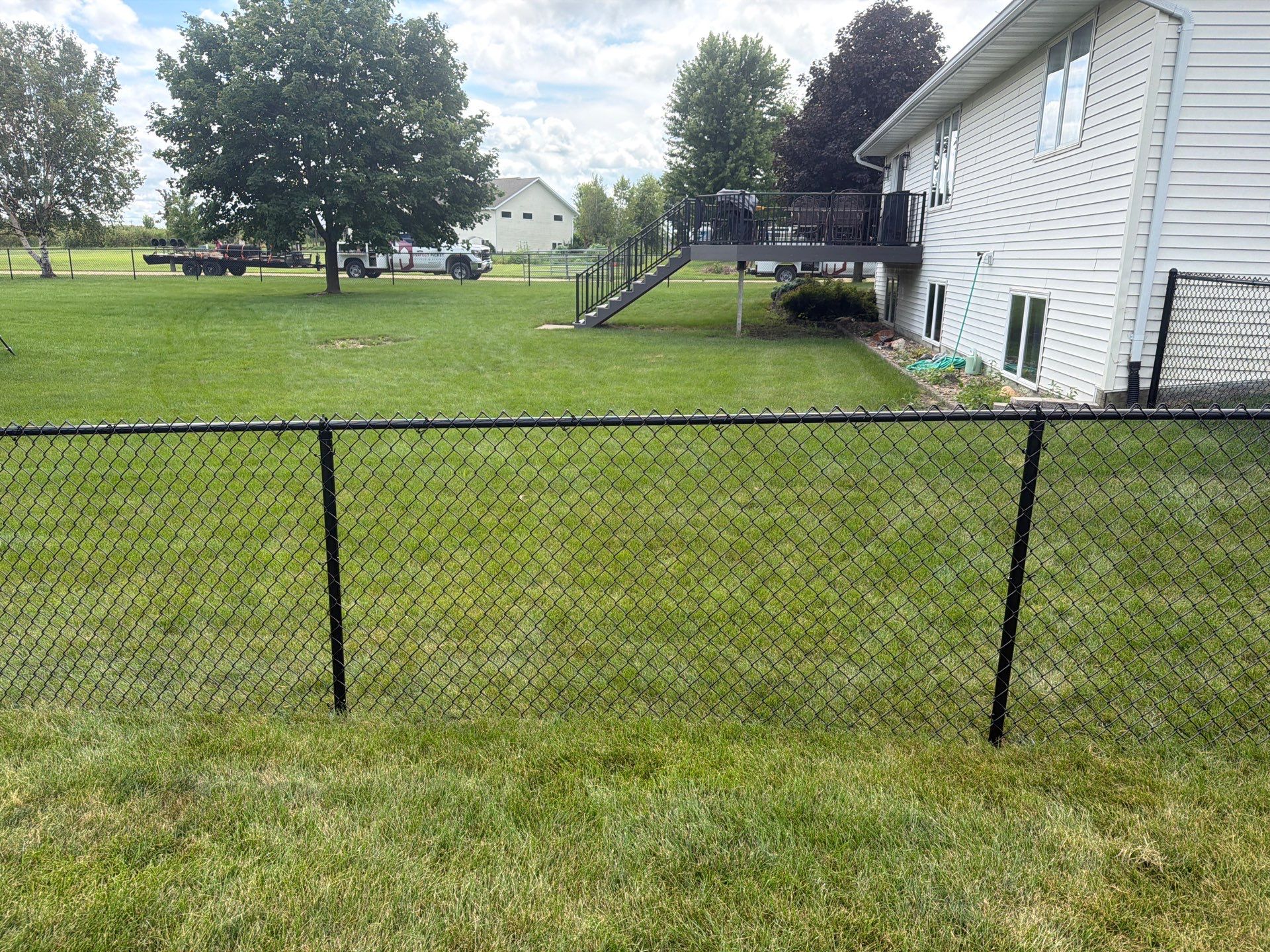 Black Vinyl-Coated Chain Link Fence Installation in Fairbank by Perfect Picket Fence and Stain