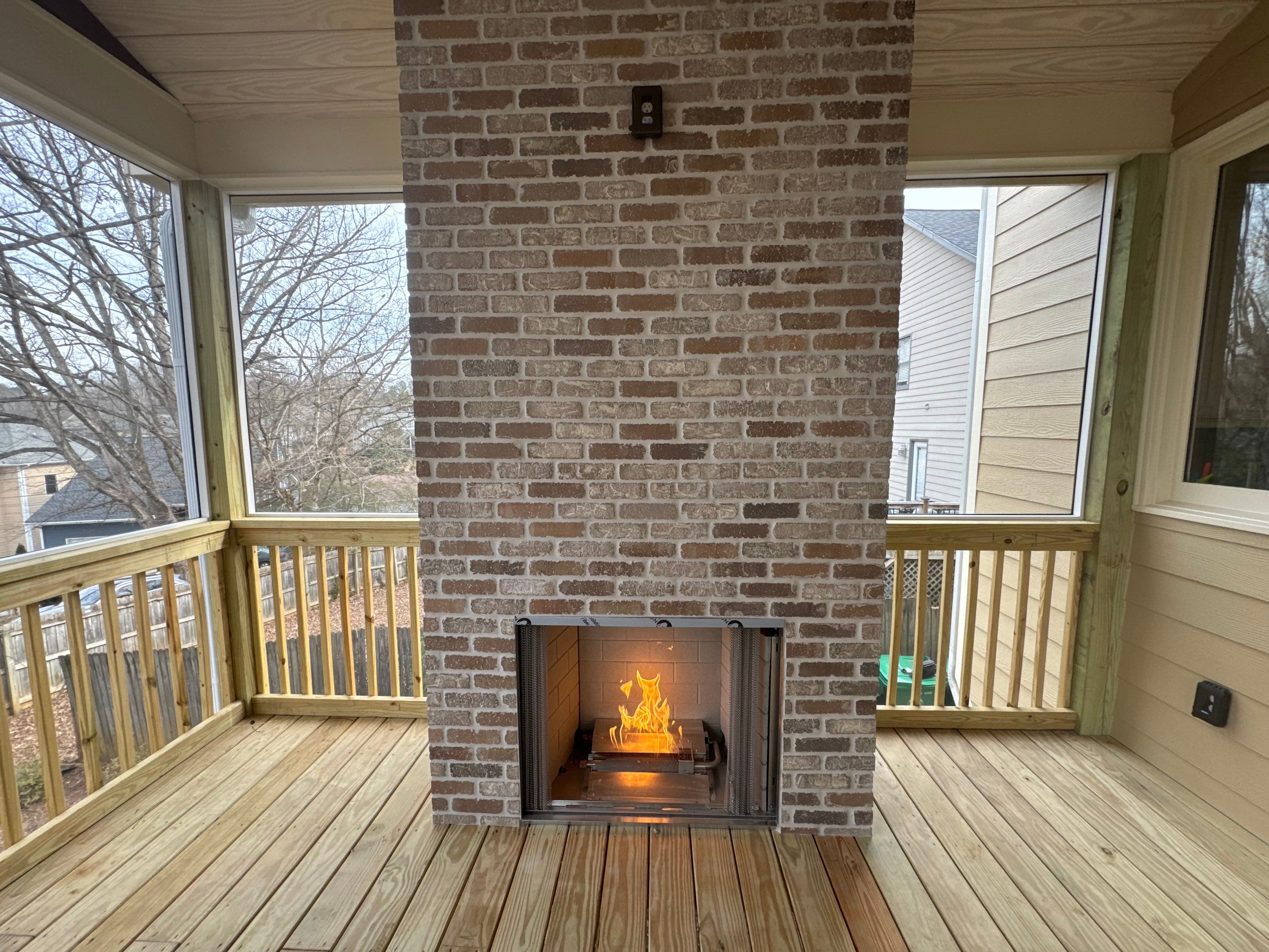 Screened-In Porch With Fireplace by Swift Home Renovations