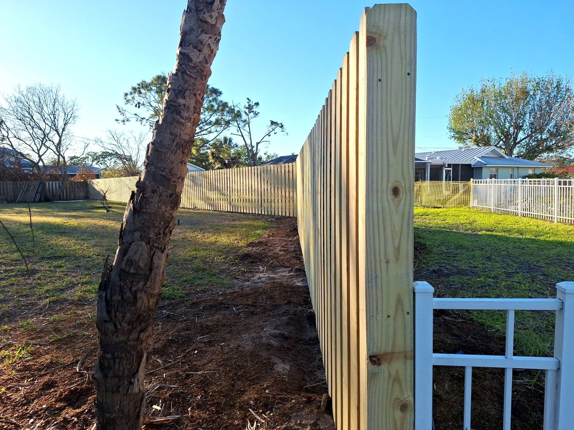 Wood Fence Installation using 6ft Pressure-Treated Wood Board-On-Board Privacy Fence with a 4Ft 3 Rail White Aluminum Fence by Asap fence and gates, LLC