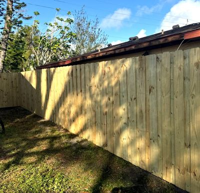 Wood Fence Installation using 6Ft Pressure Treated Wood Board On Board Privacy Fence