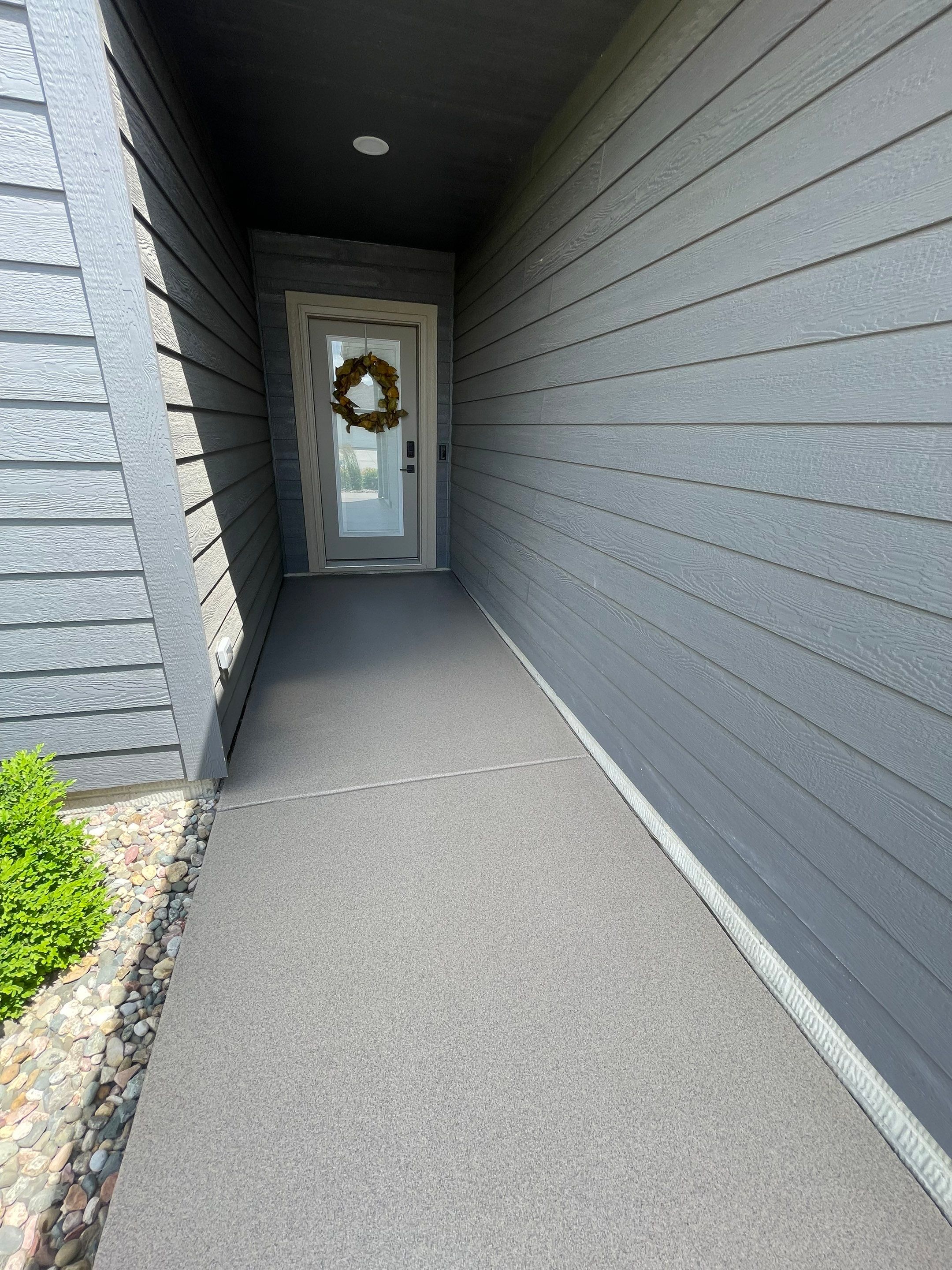 Textured Concrete Patio Coating and Custom Privacy Pergola in Sioux Falls by Select Painting, Coatings & Garage Cabinets