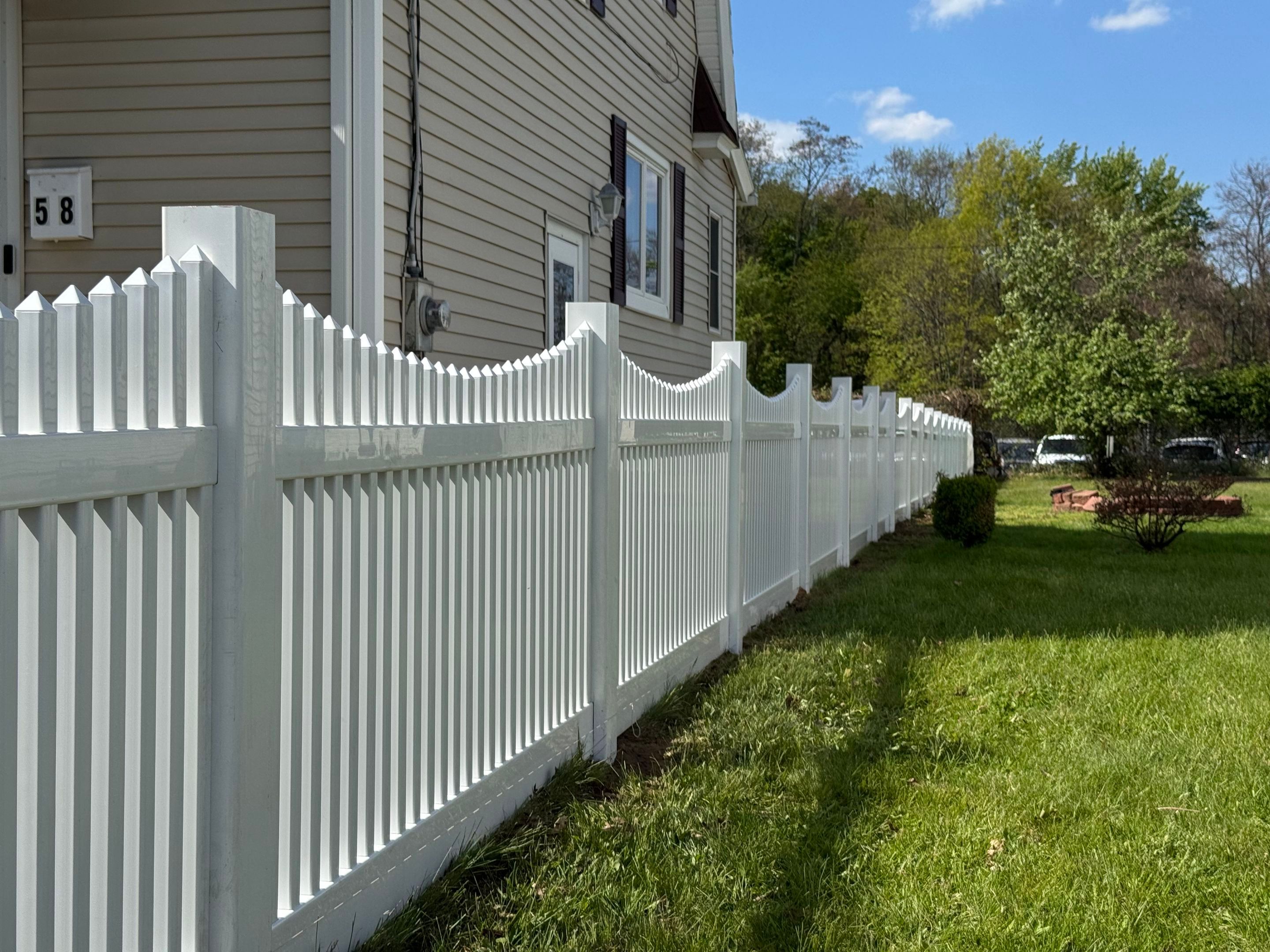 Fence replacement using White Vinyl picket with scalloped edge. by DiGiorgi Roofing and Siding Inc