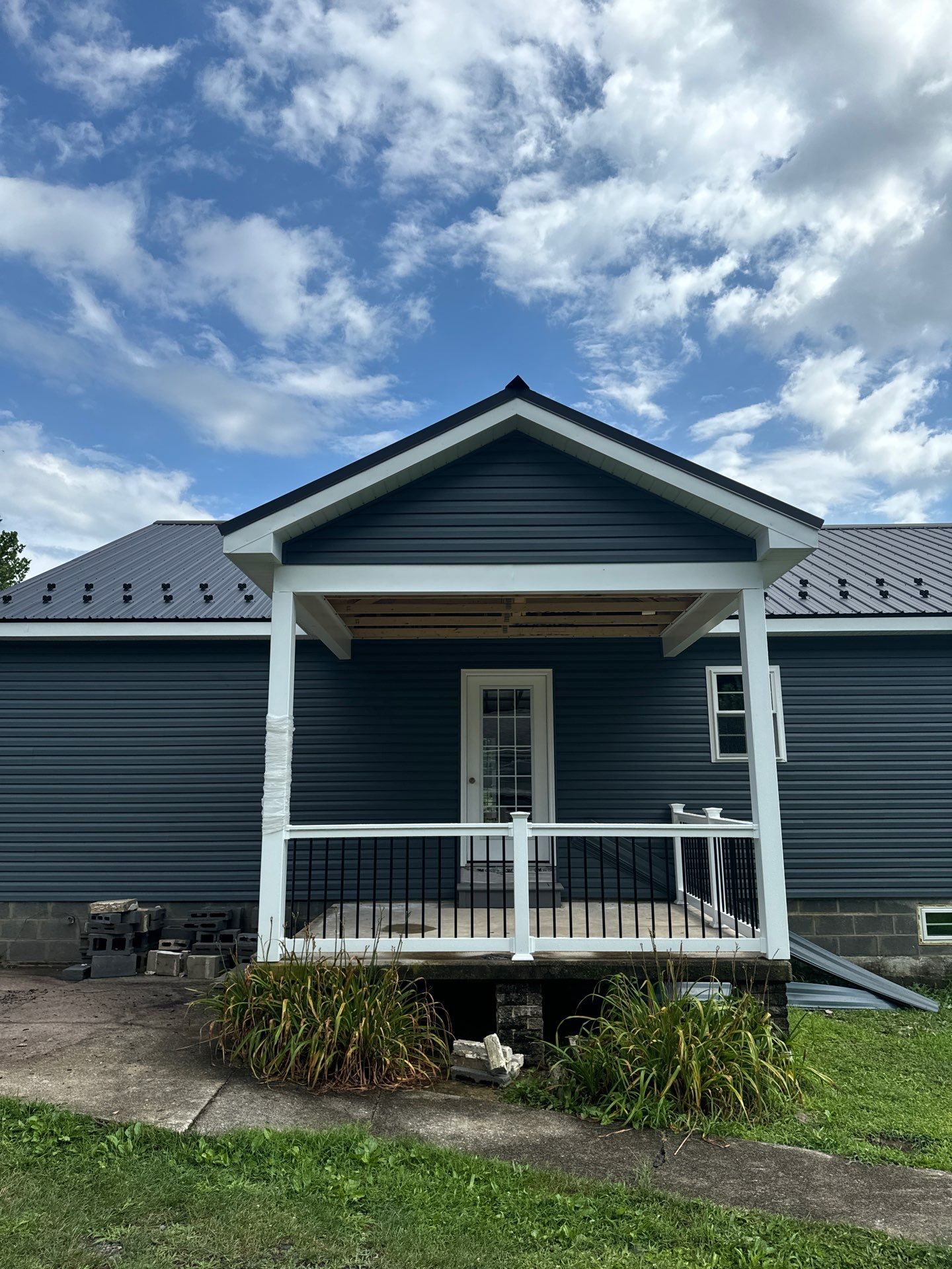 New Residential Addition with Blue Siding and Metal Roofing in Ashland by Esh Builders