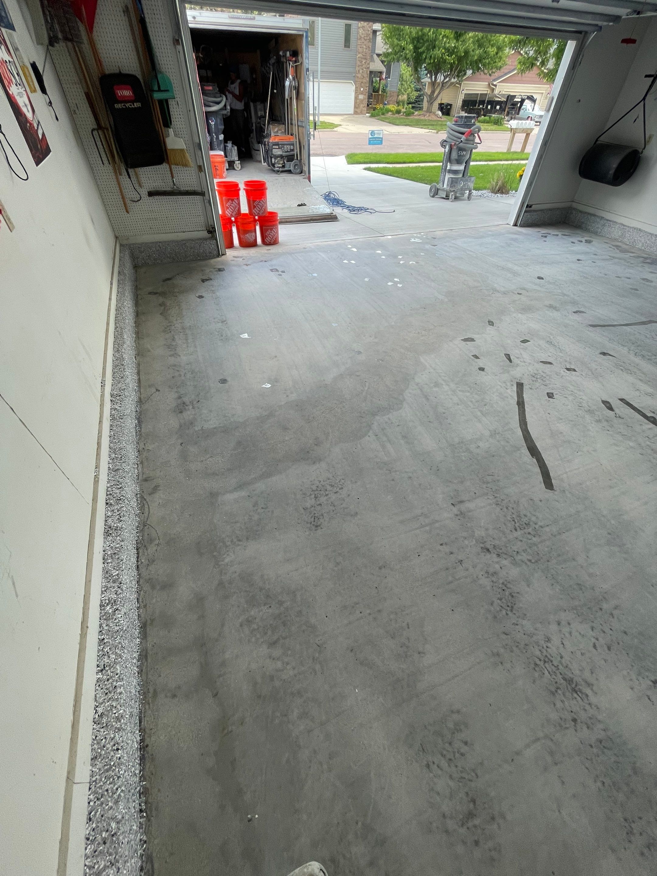 Residential Garage Floor Coating with Feather Grey Finish in Sioux Falls by Select Painting, Coatings & Garage Cabinets