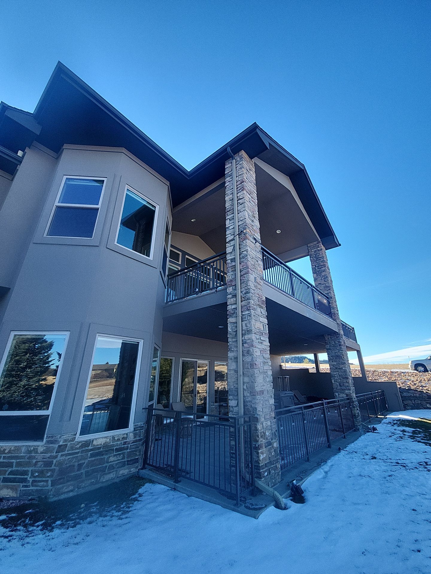 Castle Rock Elegance: White Stucco Exterior with Bold Tricorn Black by J&M Painting LLC