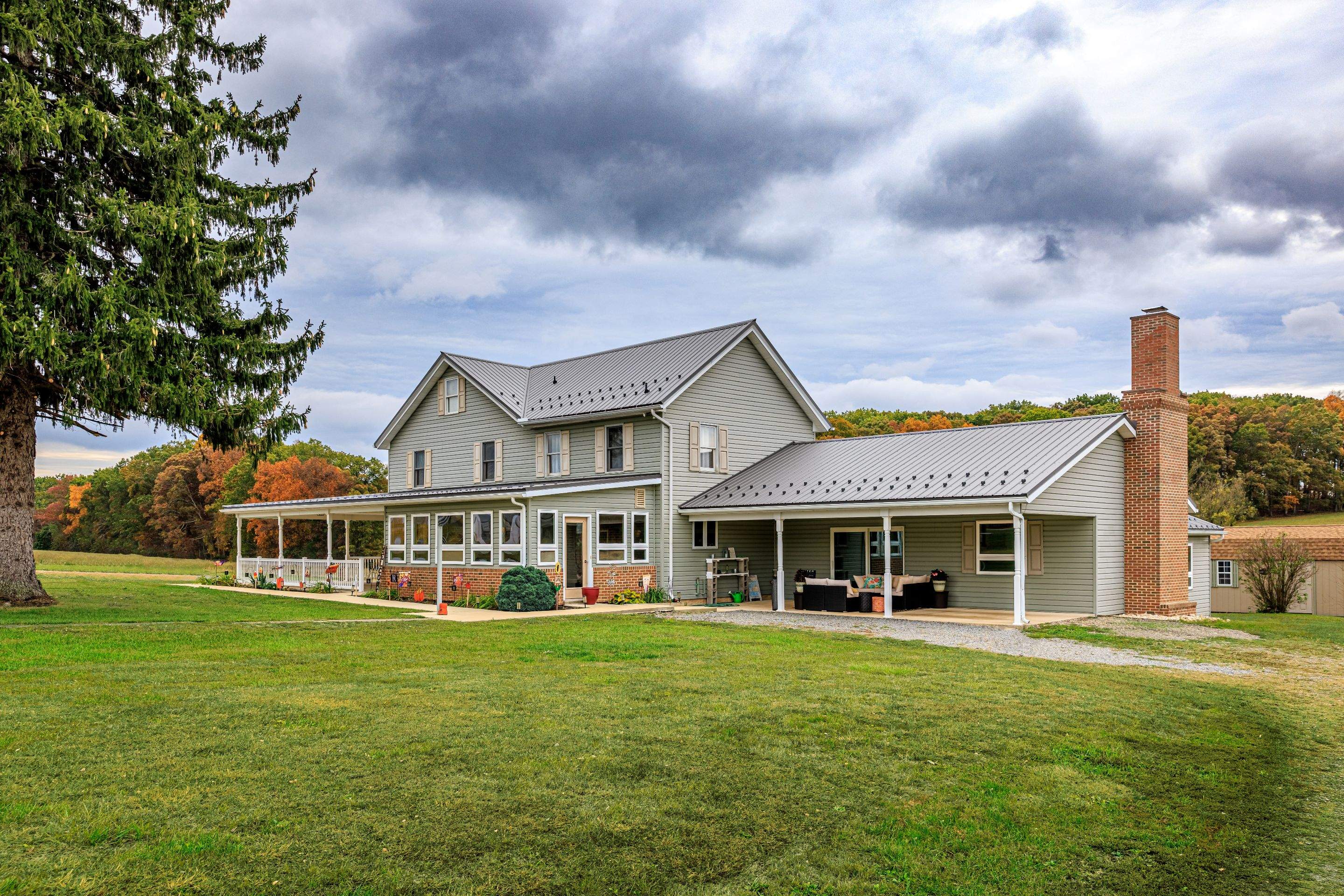 Classic Farmhouse With Textured Charcoal Metal Roof by Esh Builders