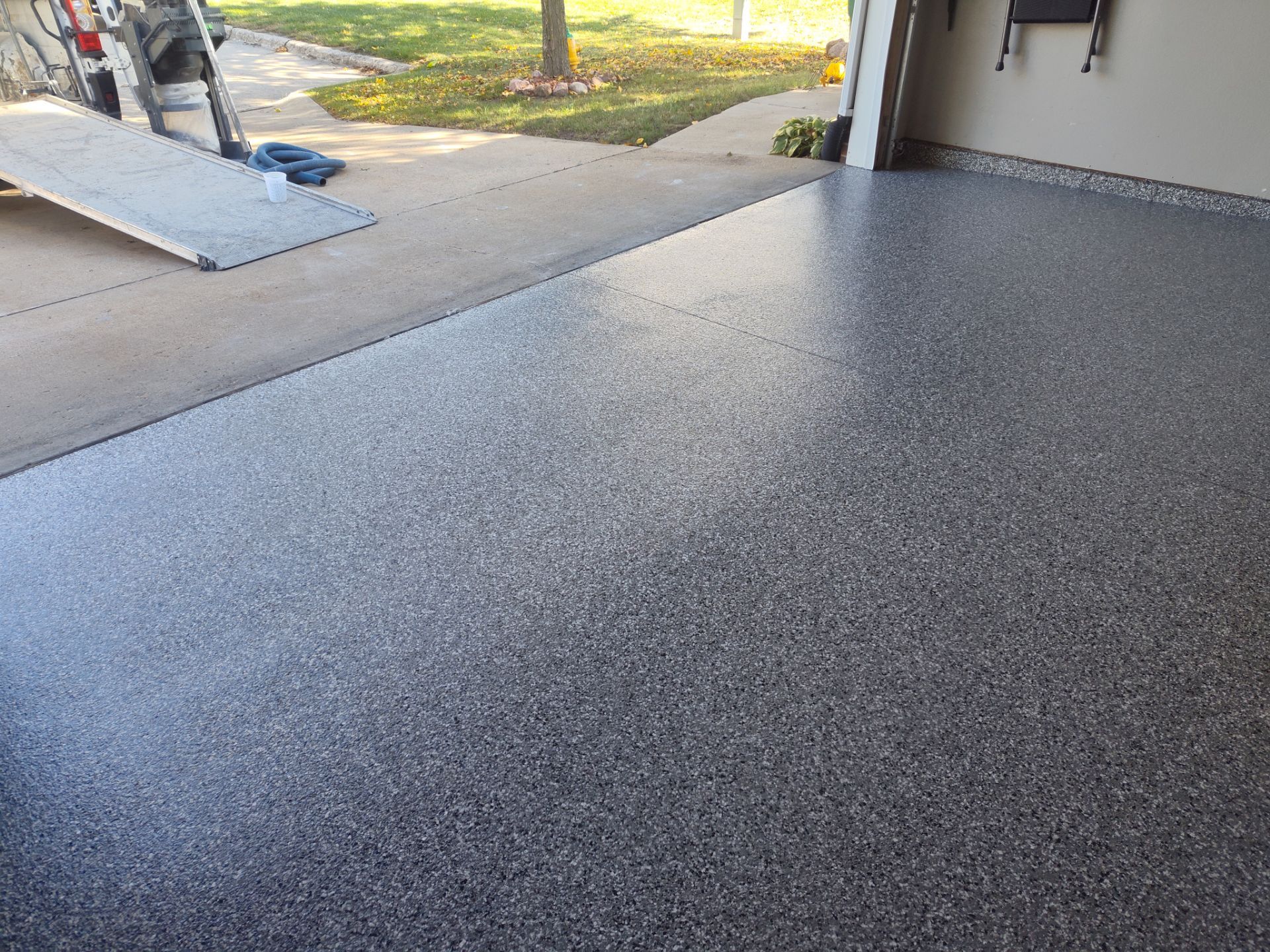 Close Up View of This Customer's New Flake Coating by Revival Concrete Coatings