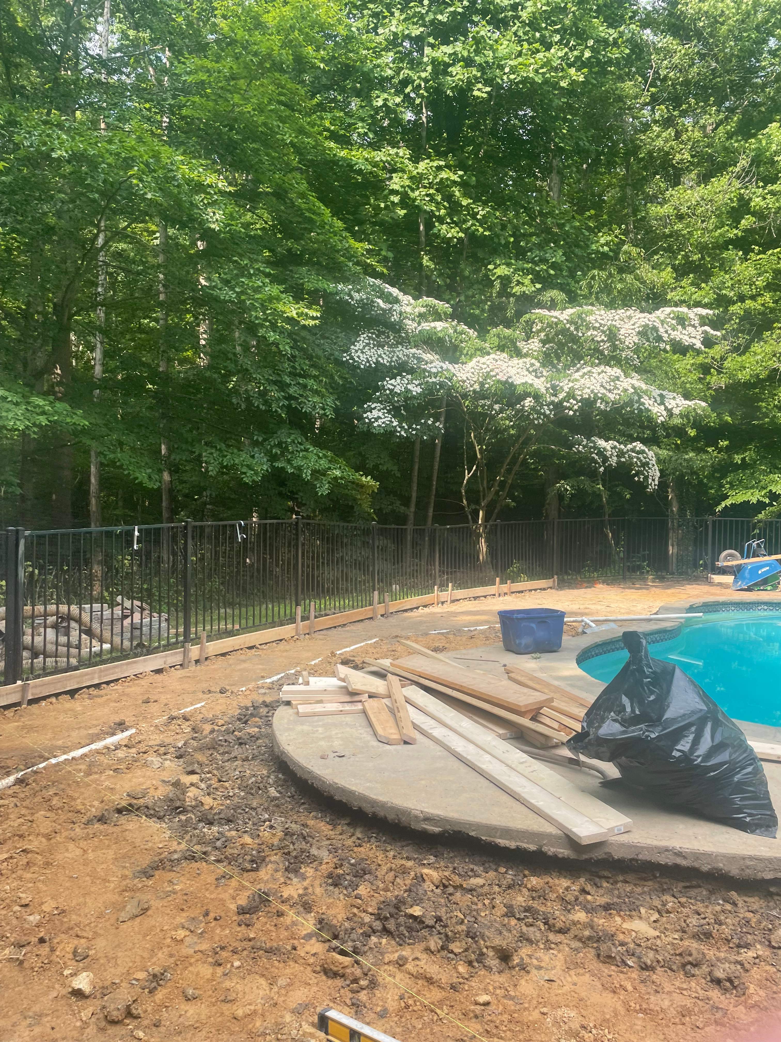 Pool Surround remodel with retaining walls, new waterfall and water slide by Fairfax Contractors, LLC