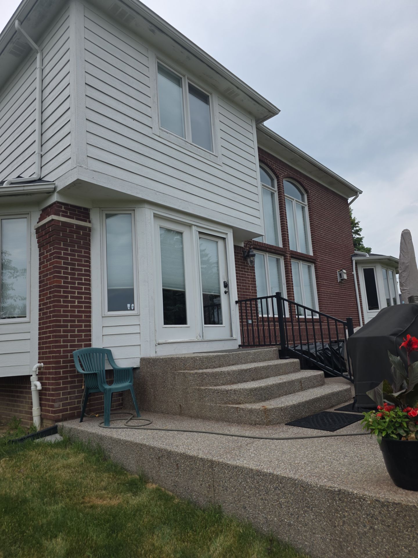 Siding and Trim Repair and Exterior Painting for a Macomb Brick Residence by Top Shelf Painter