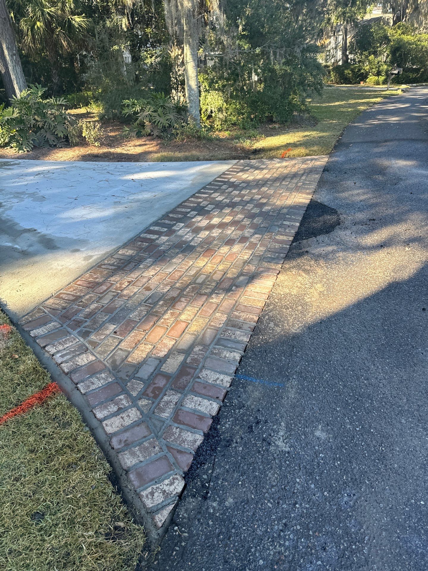 Custom Concrete Driveway Installation with Decorative Brick Borders in Okatie by Lowcountry Scapes, LLC