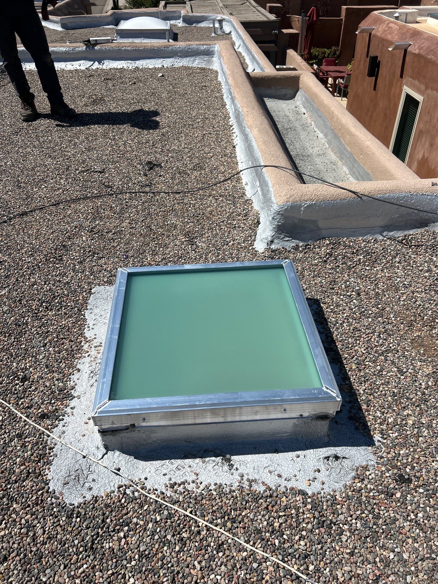 Roof Maintenance and Low-E Tempered Glass Skylight Replacement on Gravel Roof in Northwest Albuquerque by Doyle Roof Masters Inc
