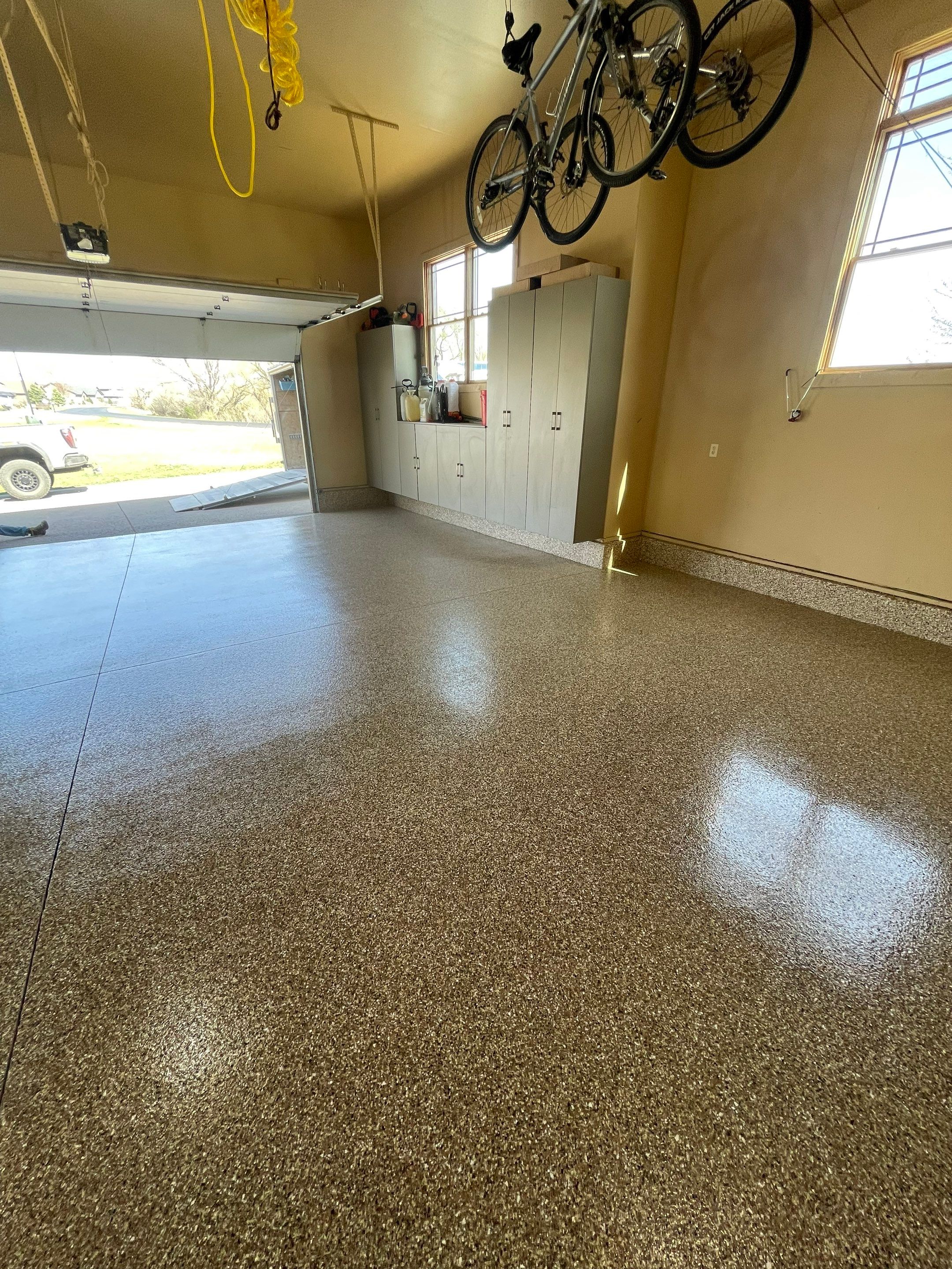 Residential Garage Floor Transformation with Speckled Epoxy Coating by Select Painting, Coatings & Garage Cabinets