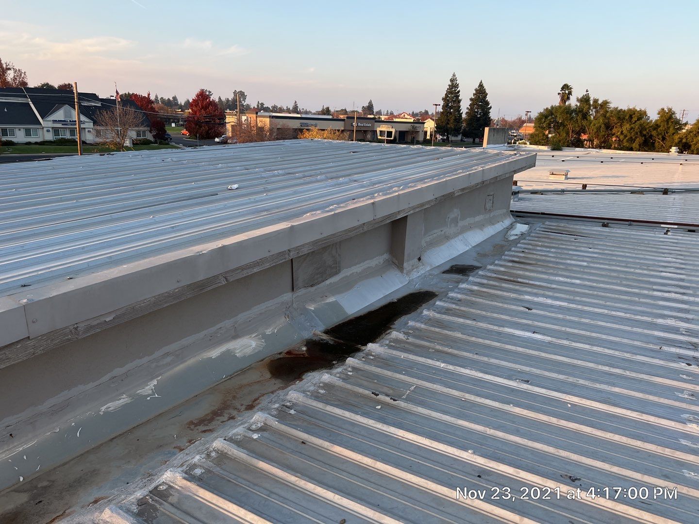 Metal roof restoration on commercial roof using Conklin Benchmark/ PUMA XL acrylic coatings over metal and foam by Straight Edge Roofing Inc