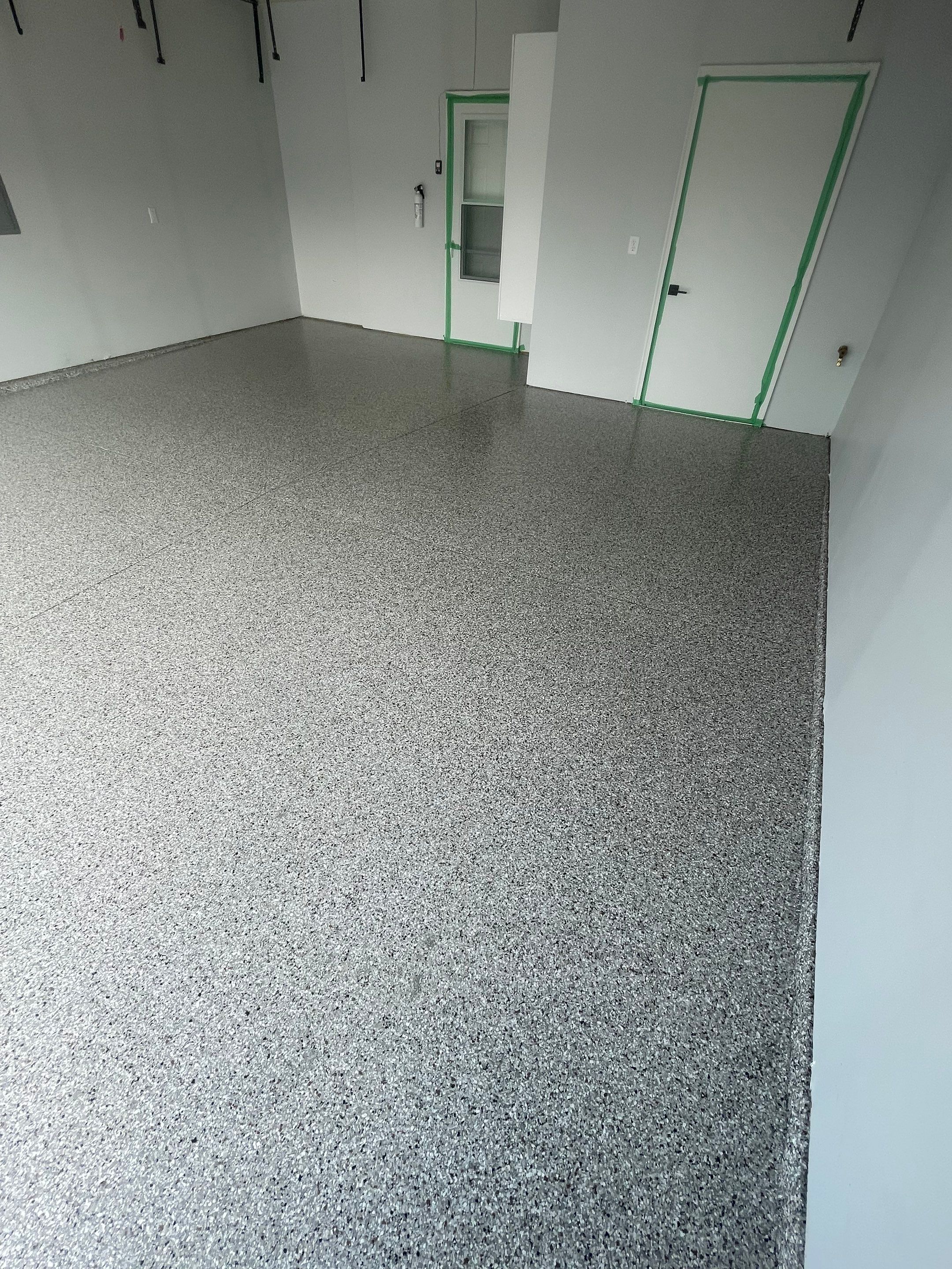 Custom Coyote Flake Garage Floor Coating in Sioux Falls by Select Painting, Coatings & Garage Cabinets