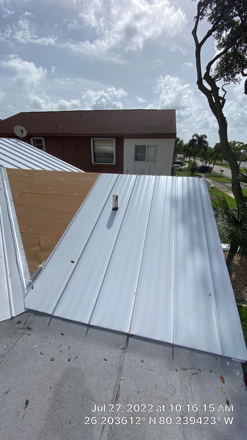 Residential Roofing Installation using 1.5" Nail Strip 24ga Solar White Kynar Coated Standing Seam Metal Panels by Morton Roofing, Inc.