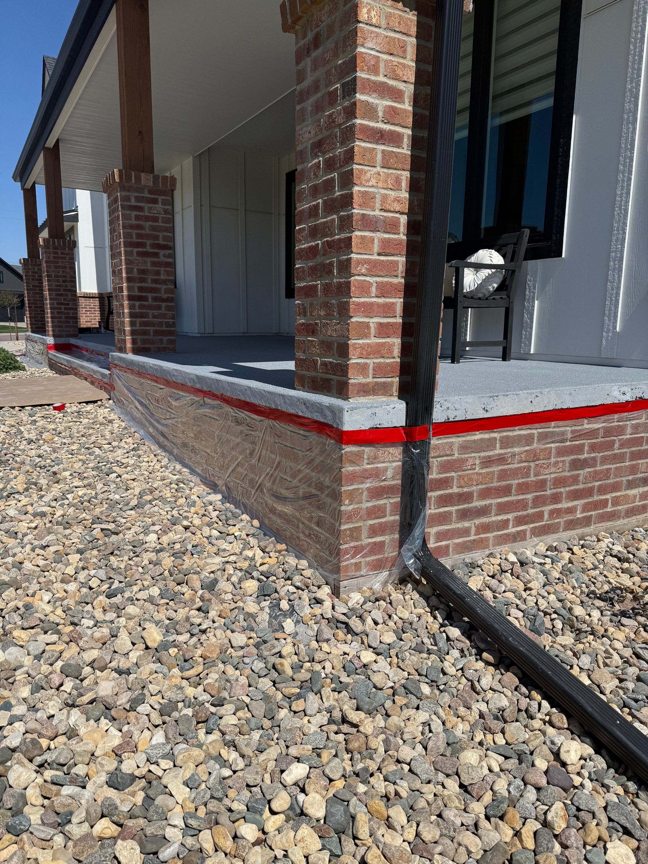 Grey Speckled Concrete Porch Coating for Sioux Falls Home by Select Painting, Coatings & Garage Cabinets
