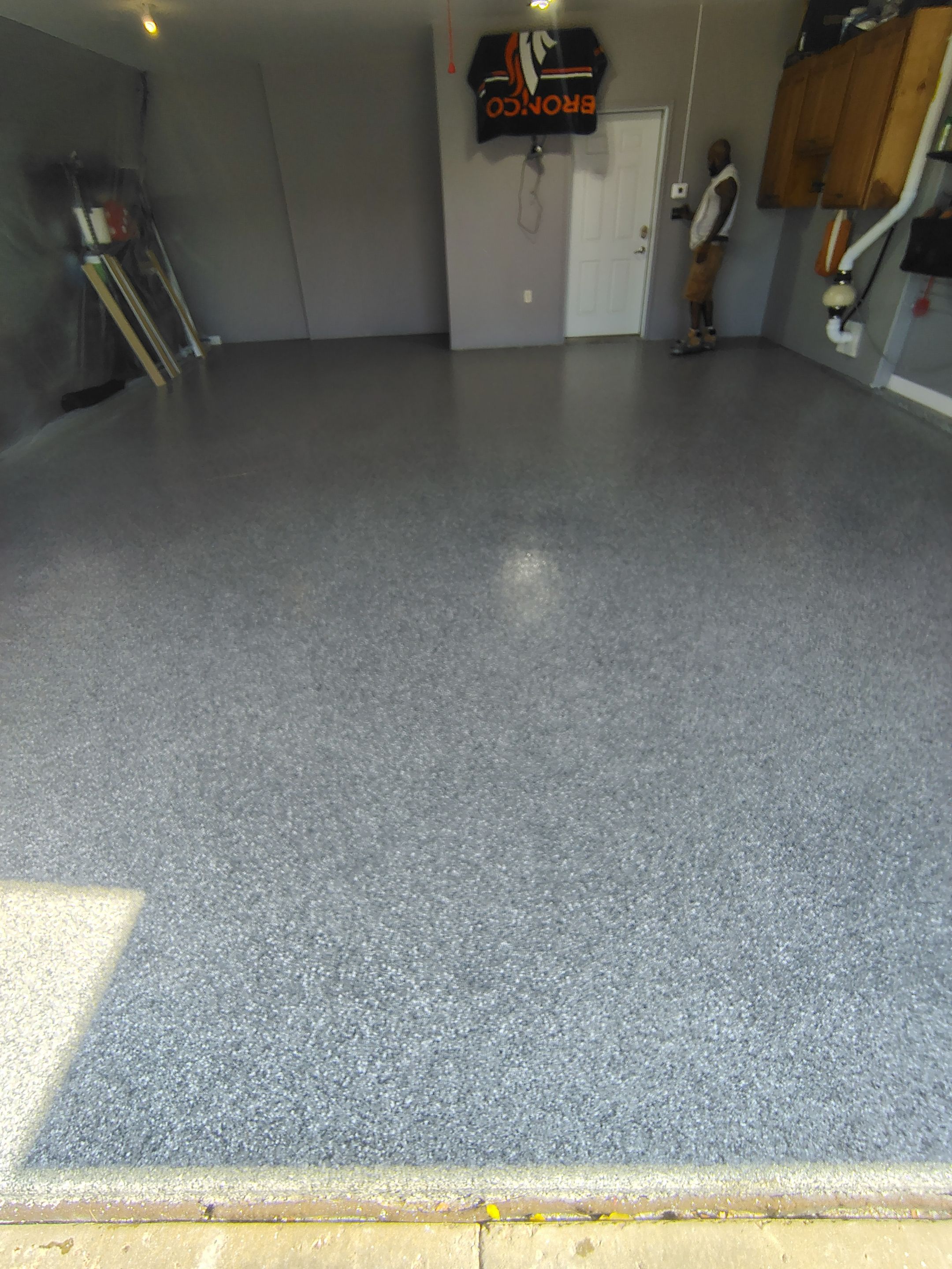 Grey Flecked Epoxy Garage Floor Installation in Sioux Falls by Select Painting, Coatings & Garage Cabinets