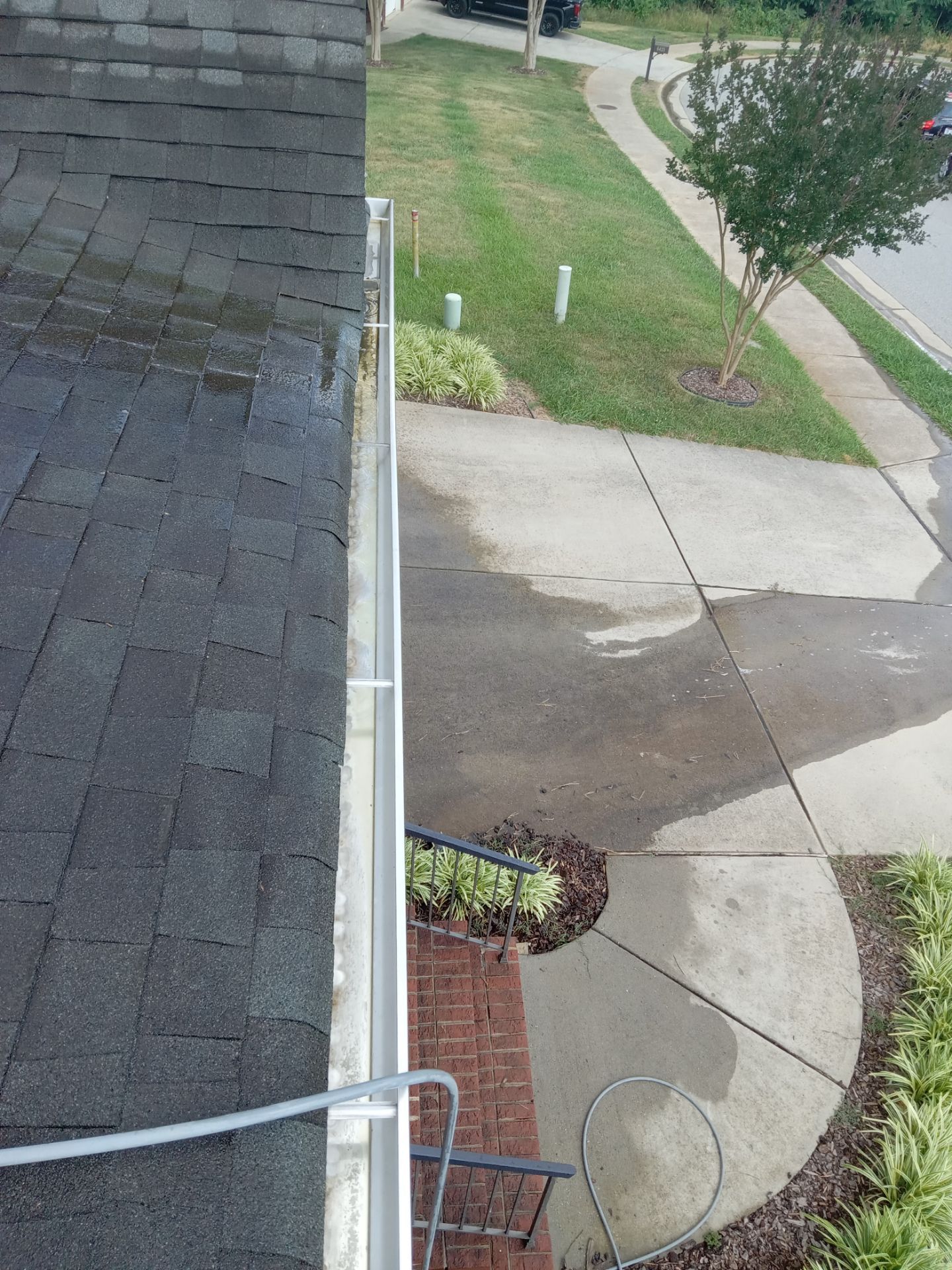 pressure washing driveway and walkway removing dirt and stains restoring surfaces to clean appearance