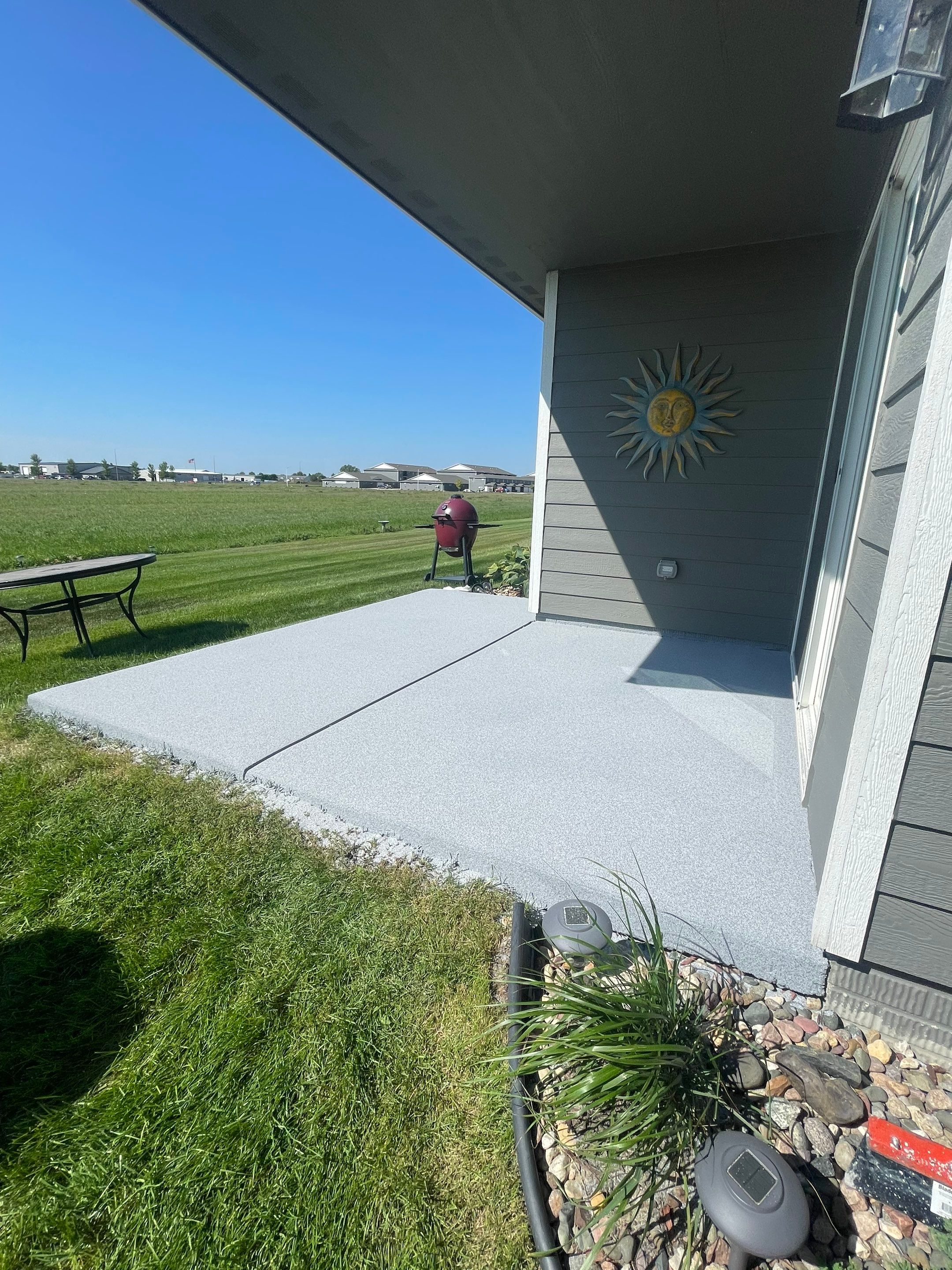Starry Evening Concrete Patio Coating Installation in Tea by Select Painting, Coatings & Garage Cabinets
