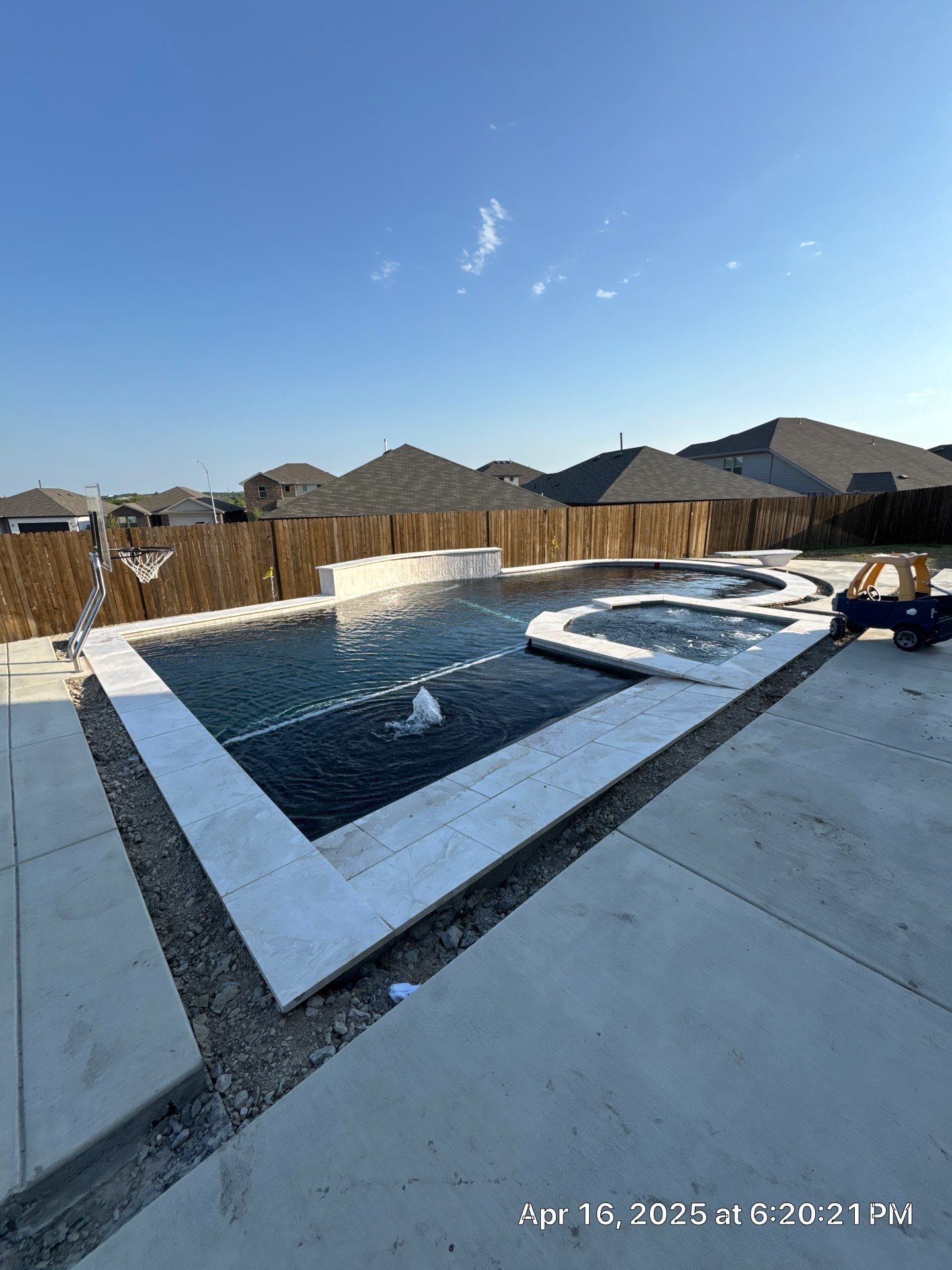 Geometric Pool with Spillover Spa and Dark Interior by Pinnacle Pools and Spas - DFW