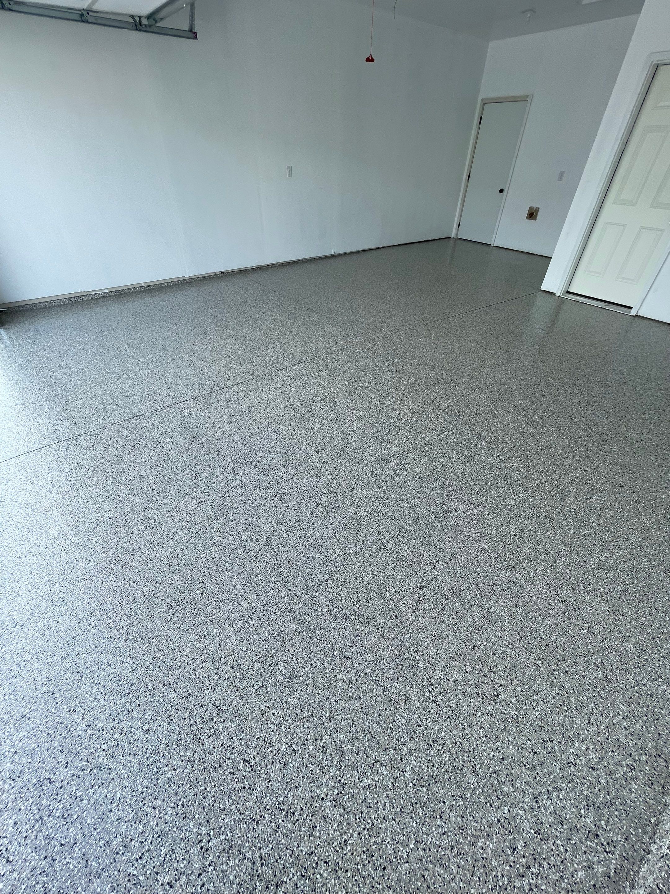 Sioux Falls Garage Floor Transformation with Cabin Fever Decorative Chips by Select Painting, Coatings & Garage Cabinets