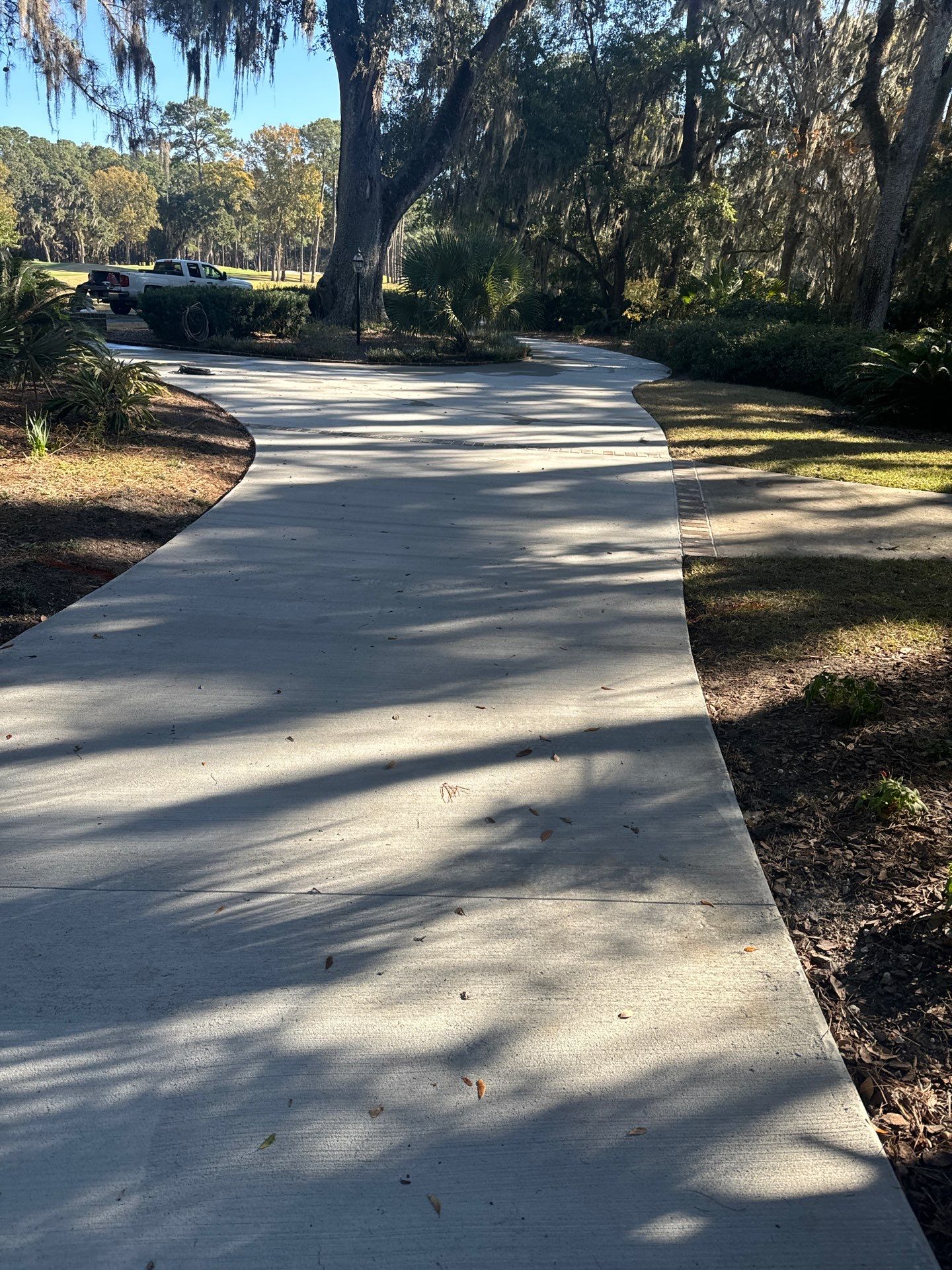 Custom Concrete Driveway Installation with Decorative Brick Borders in Okatie by Lowcountry Scapes, LLC