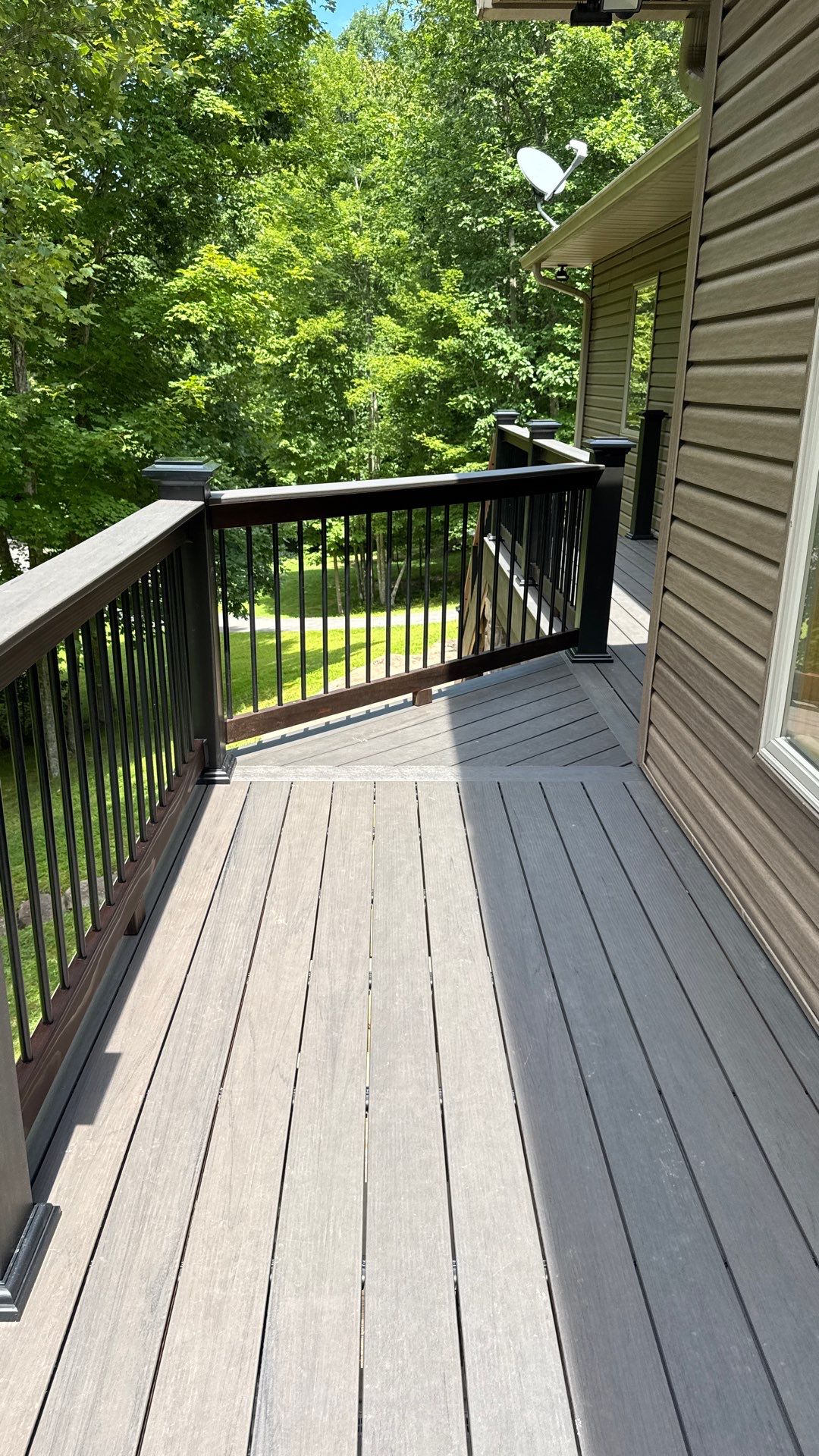 Custom Composite Deck Construction with Stone Pillars in Fayetteville by Walnut Hollow Decks & Outdoor Living